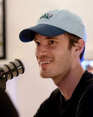 PewDiePie (Felix Kjellberg) smiling in front of a microphone on the Cold Ones podcast, July 2019