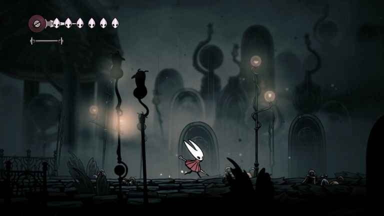 Hollow Knight: Silksong — Hornet runs along a dark stone walkway among tall lamps and arched doors.
