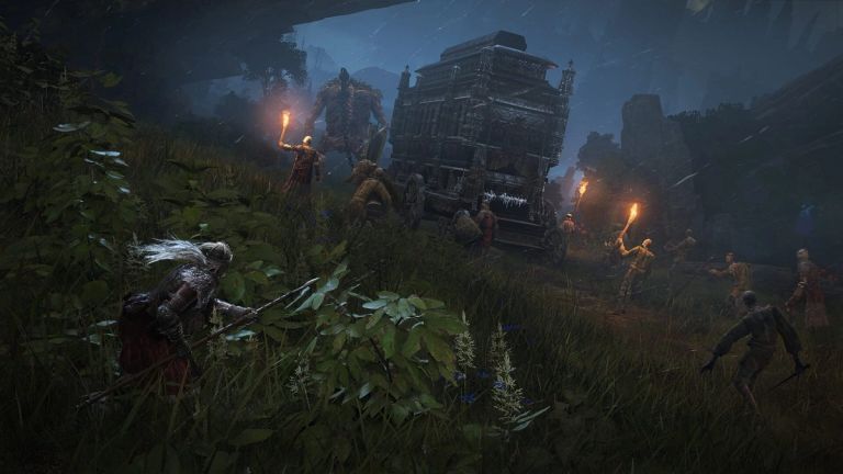 Elden Ring: An armored traveler watches torch-bearing figures escort a covered wagon through a rocky pass.