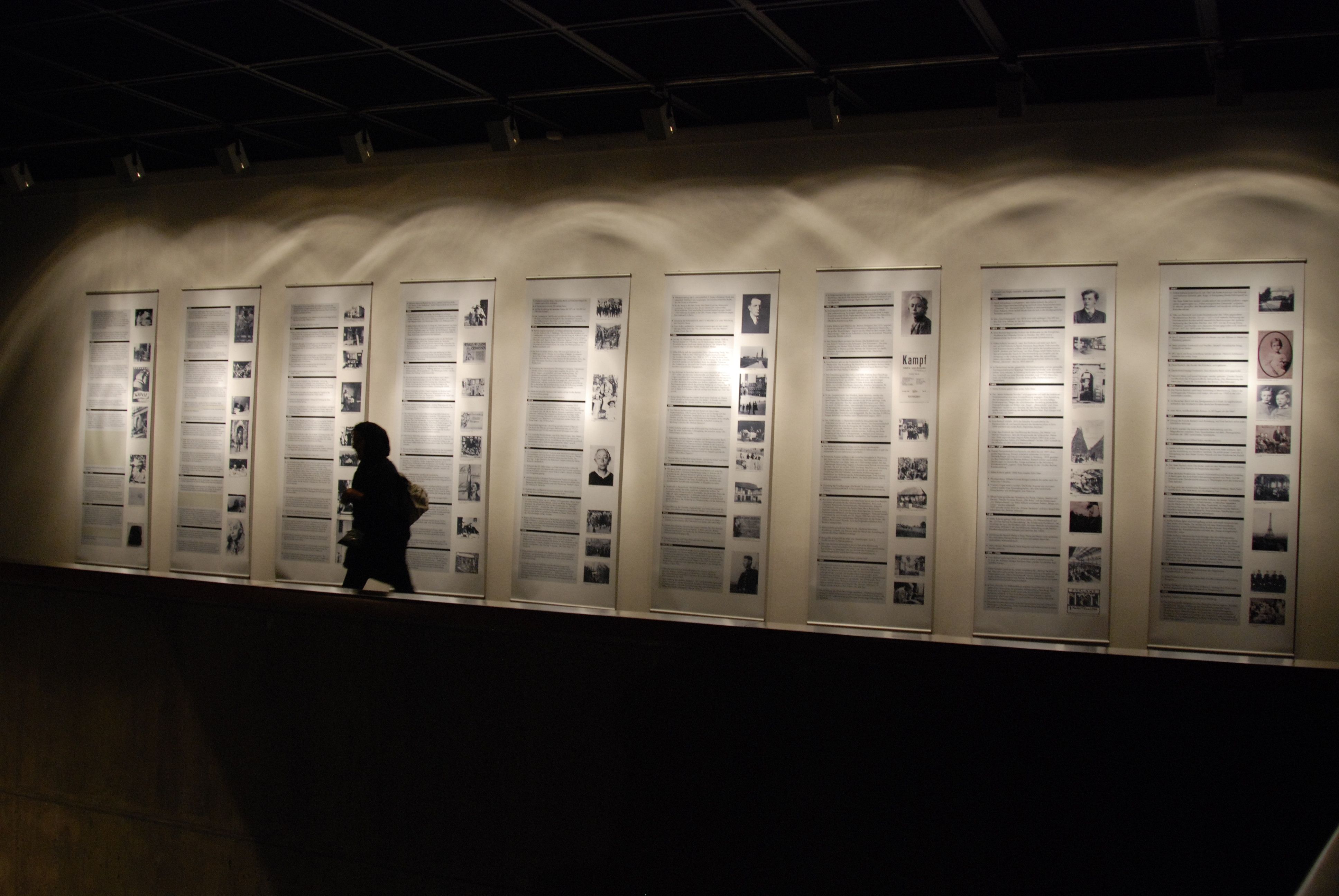 Visitor in front of the historical chronology in the exhibition Barlach Kollwitz Tehran
