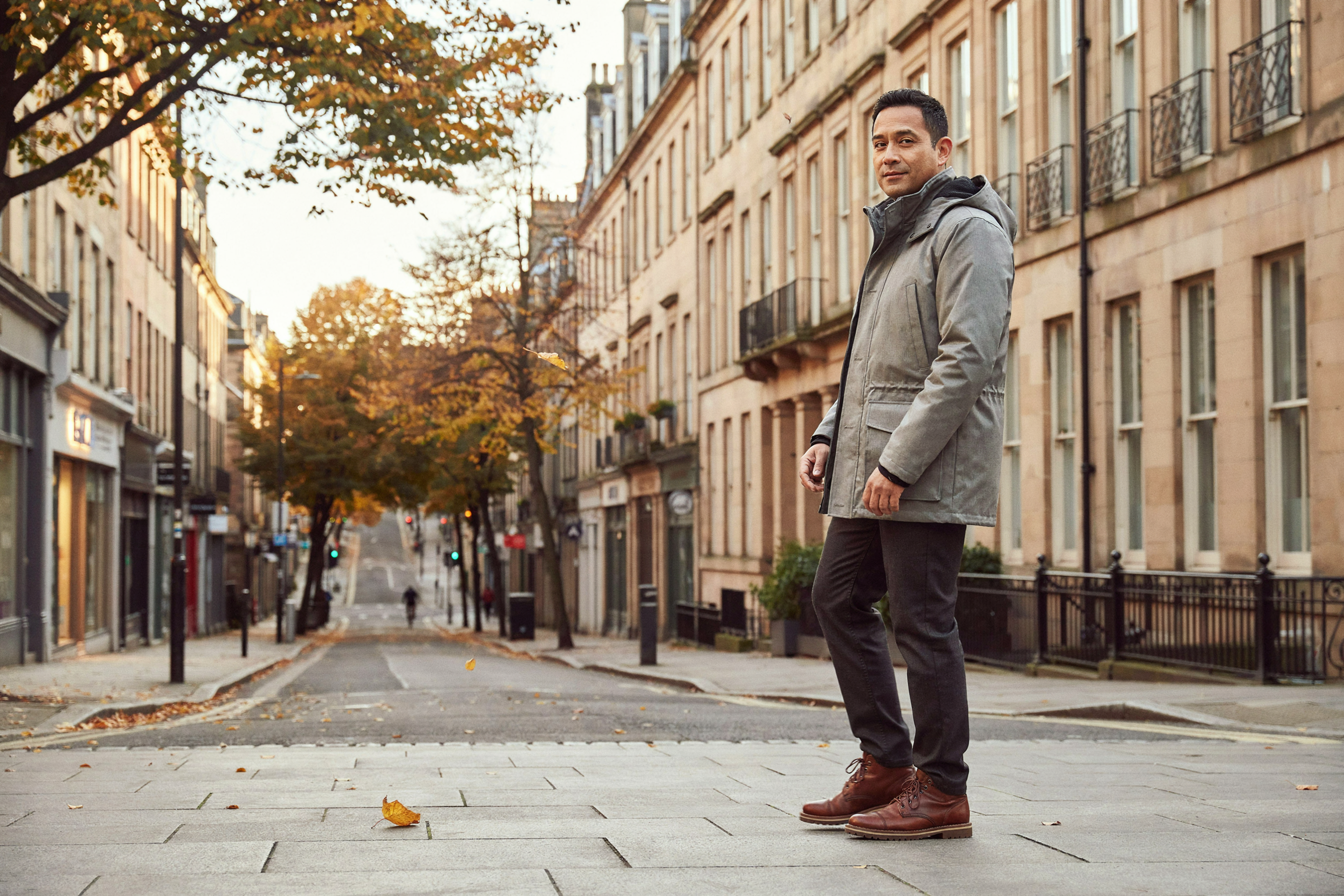 Adult walking along Bruntsfield Place in Edinburgh on an autumn afternoon, back to their day after a flu vaccination
