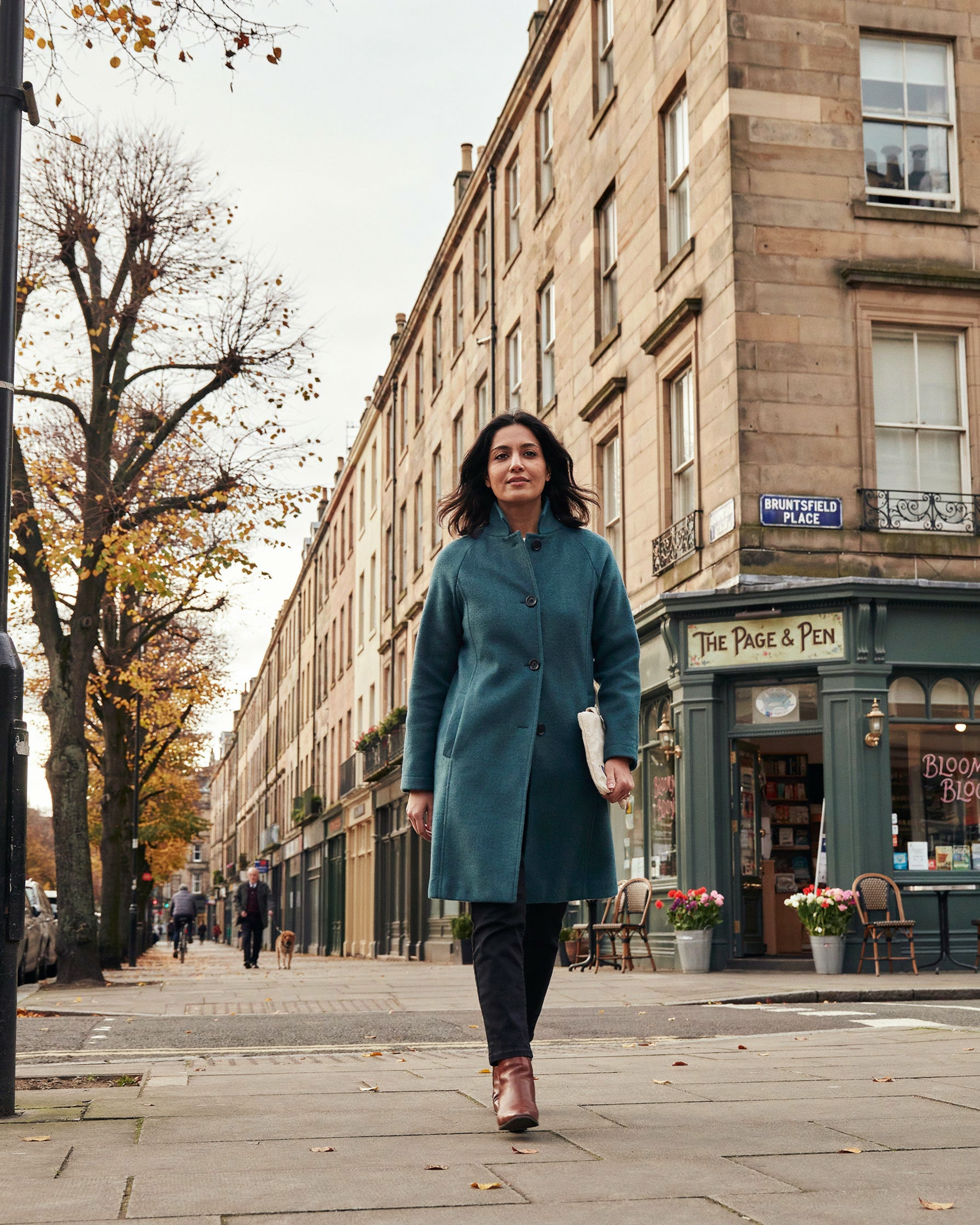 Person walking along Bruntsfield Place, Edinburgh, on a bright morning