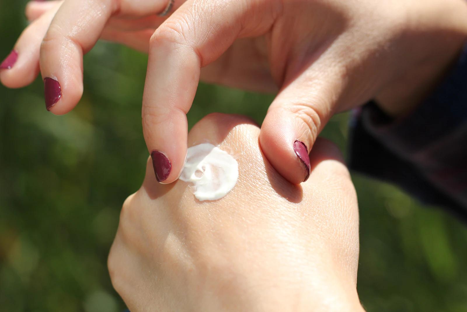 Person applying cream to their skin