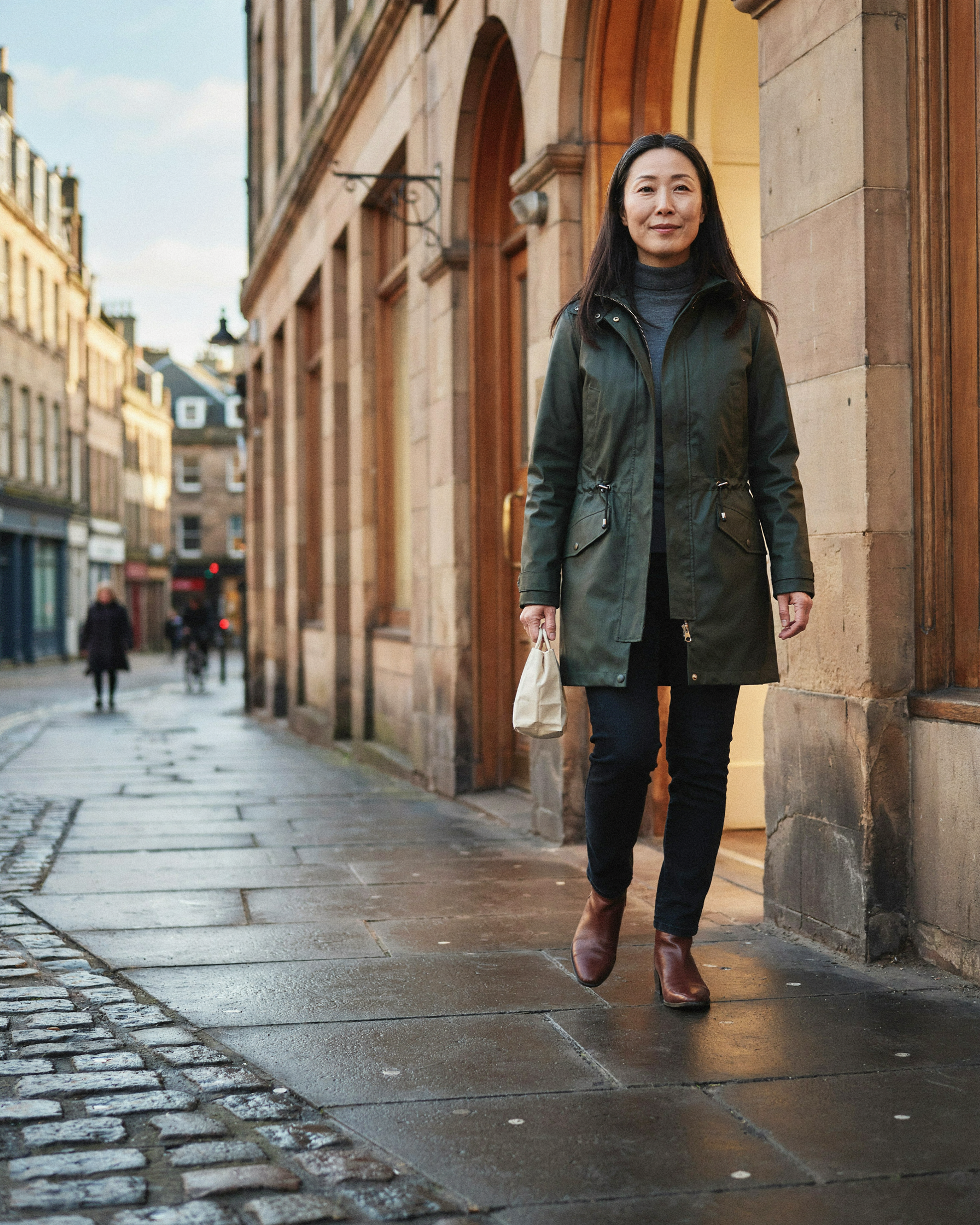 Adult stepping out of Bruntsfield Pharmacy onto a sunny Edinburgh street after a weight management consultation