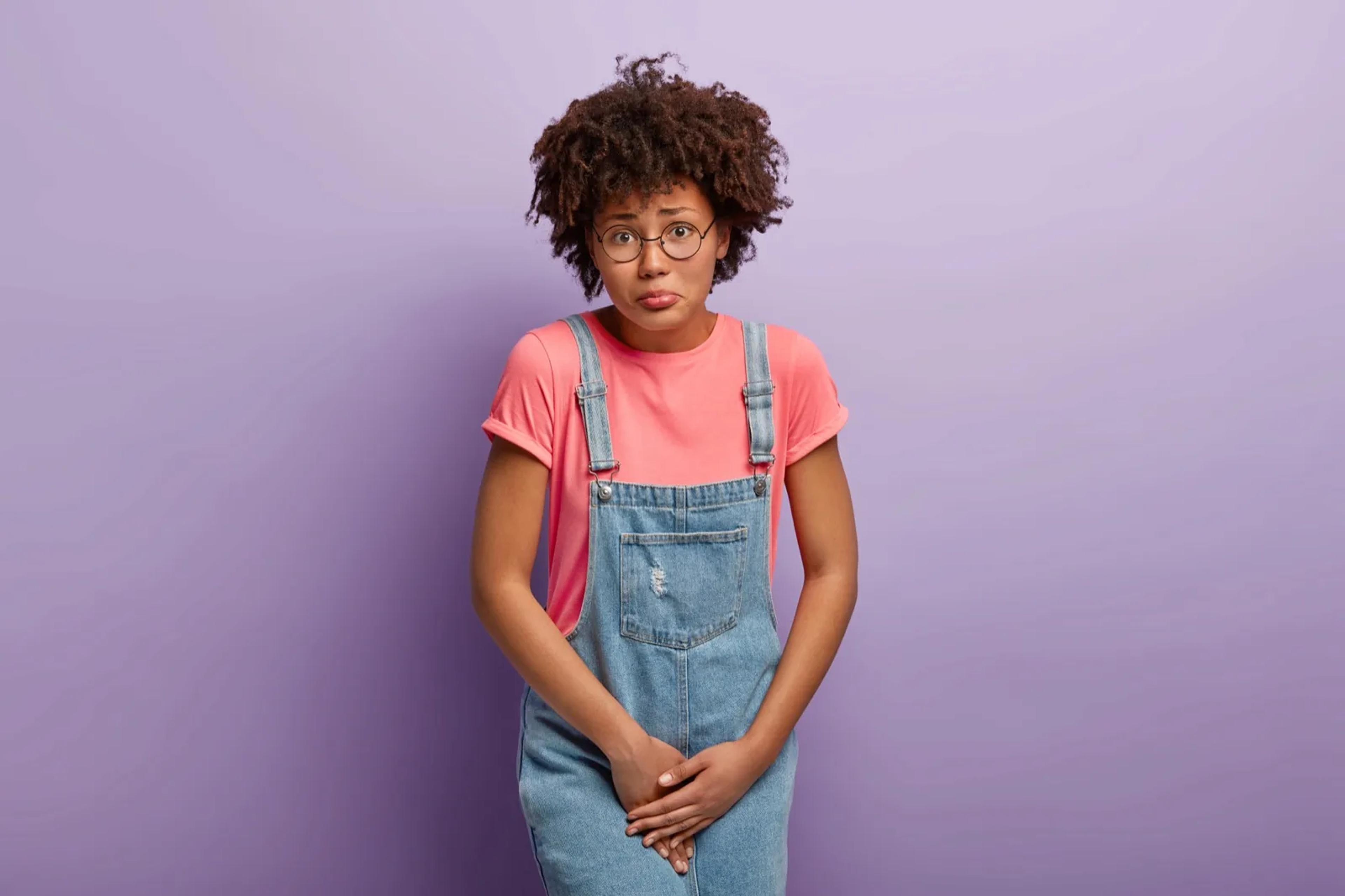 girl holding private area due to urinary tract infection