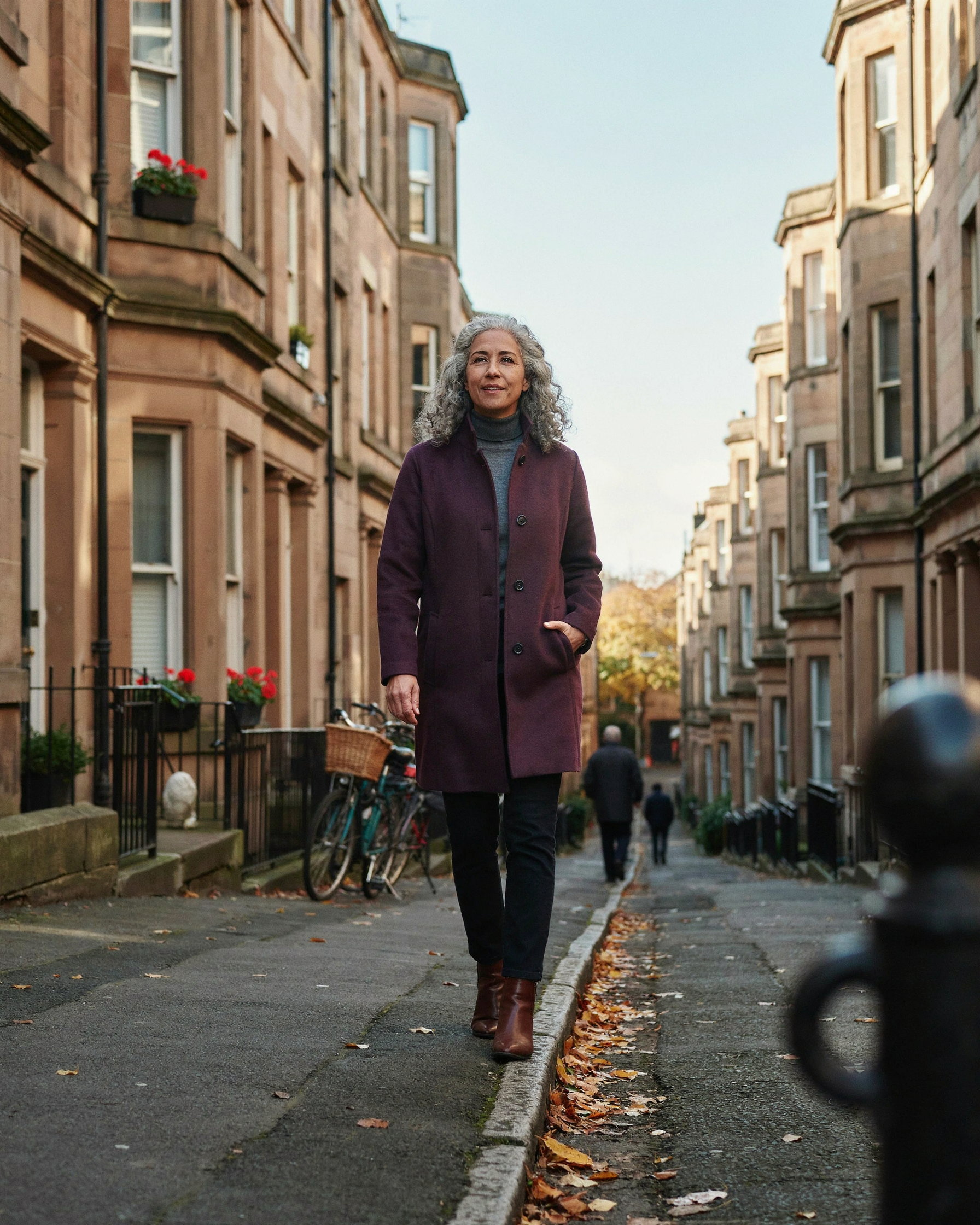 Adult walking through Marchmont in Edinburgh on an autumn morning, checking whether they qualify for a free NHS flu jab