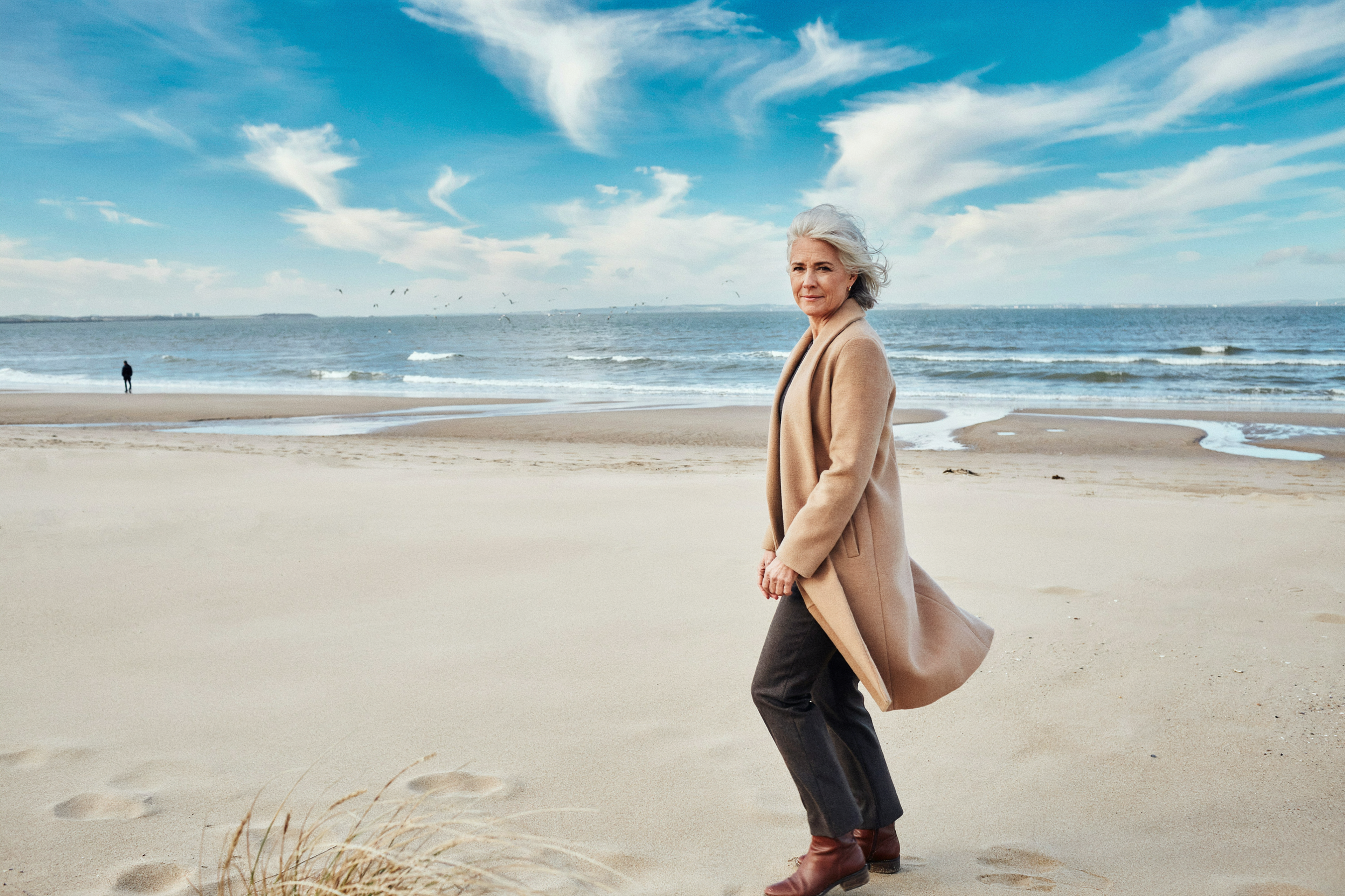 Adult walking along Portobello Beach near Edinburgh, comfortable and at ease with their health routine