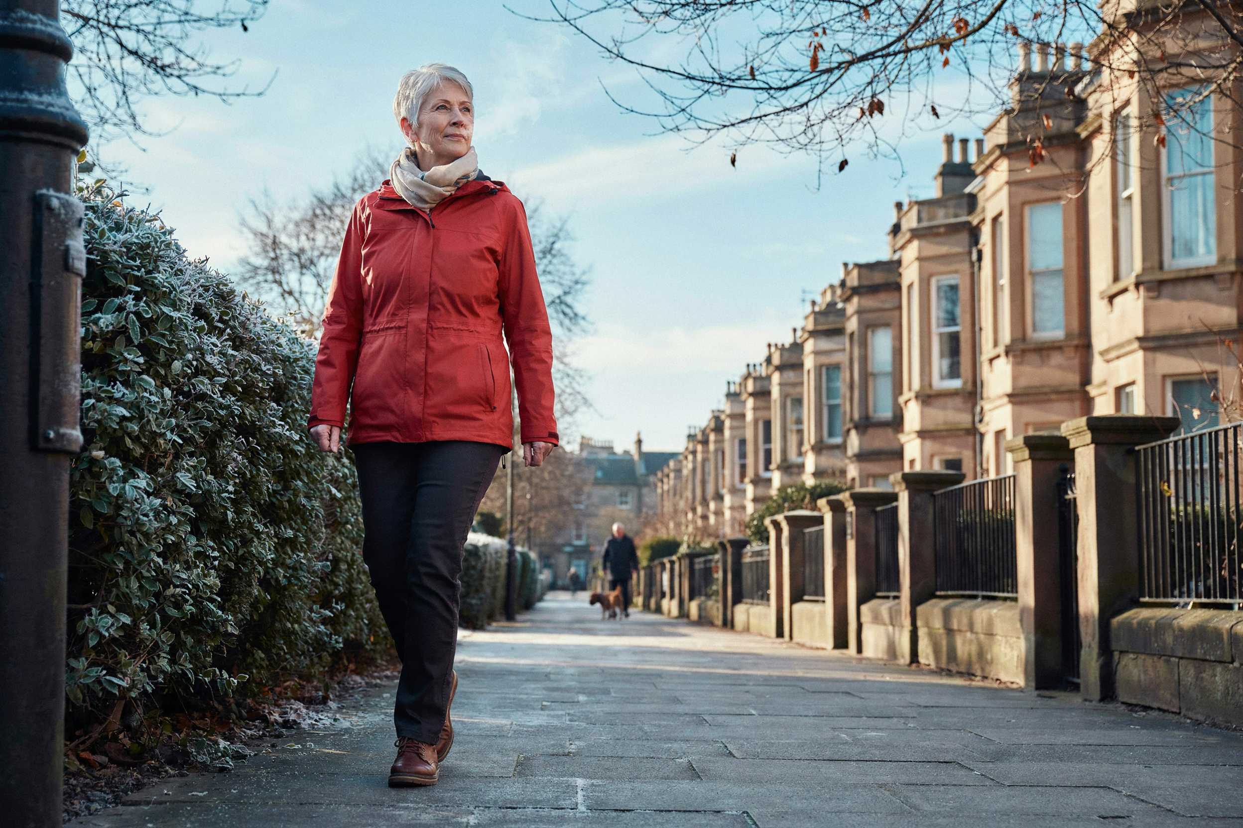 Adult walking along a frosty Morningside street in Edinburgh on a winter morning, well during flu season