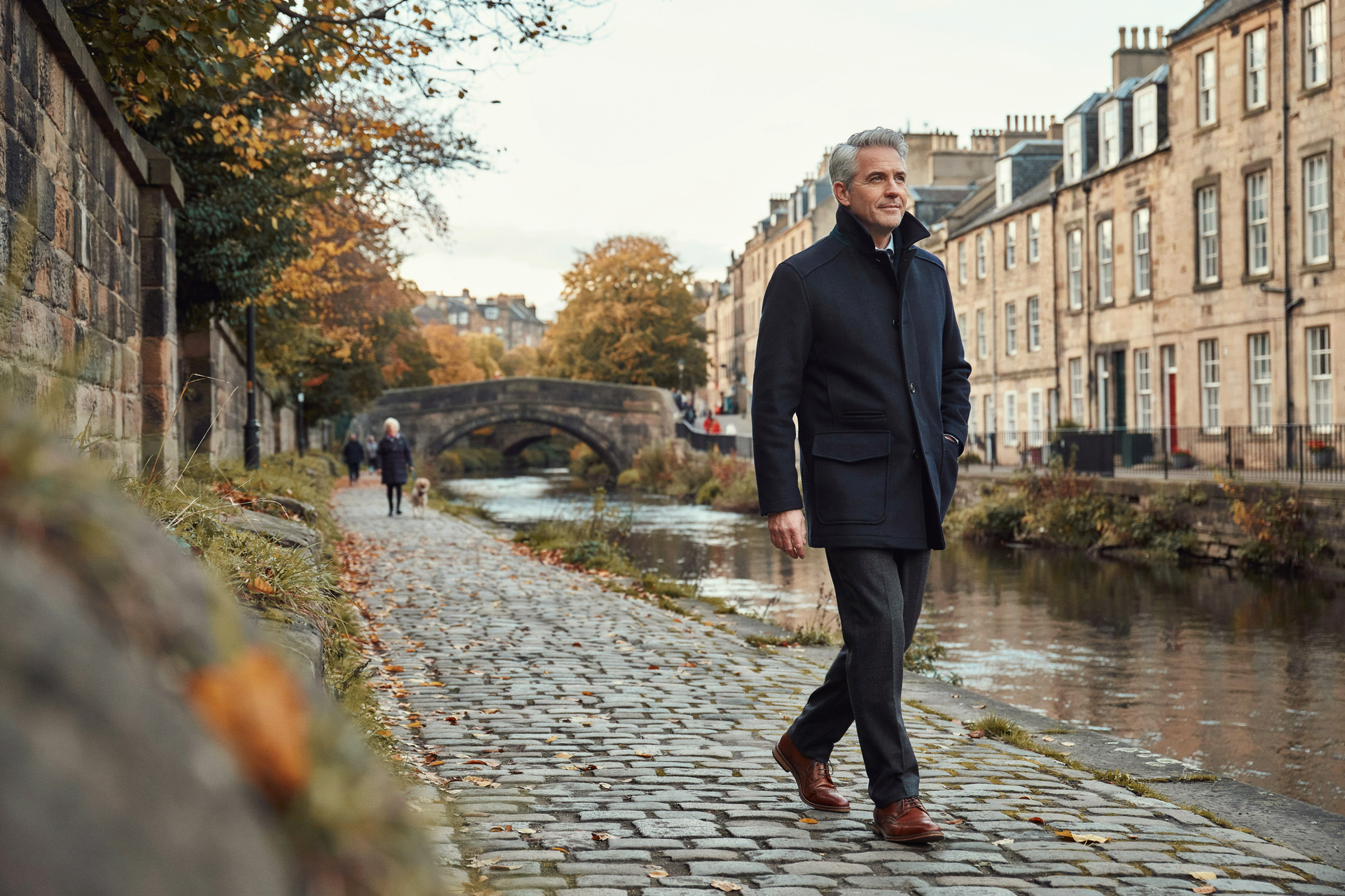 Adult walking beside the Water of Leith in Dean Village, Edinburgh, feeling well in the days after a flu jab