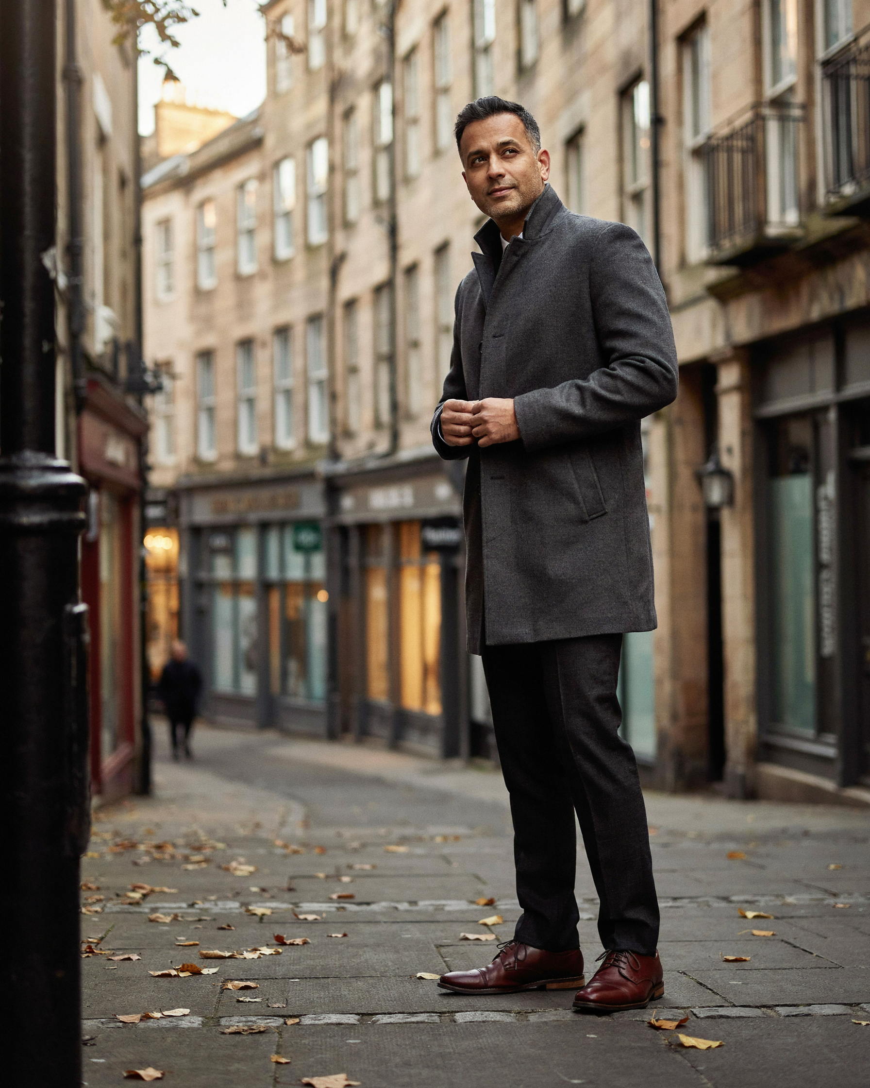 Adult stepping out onto a sunny Edinburgh street after a private flu jab appointment at a local pharmacy