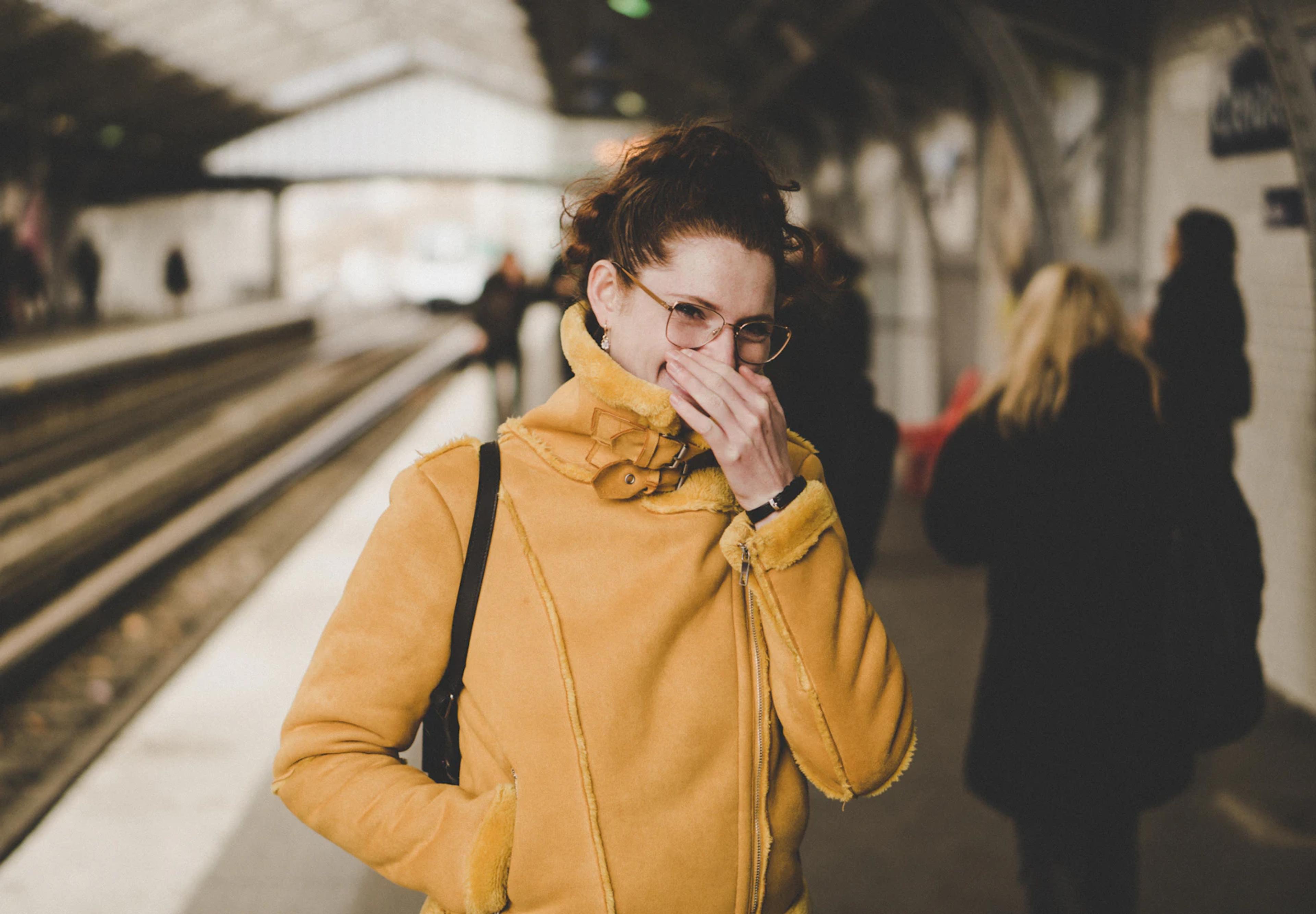 Woman coughing and covering her mouth
