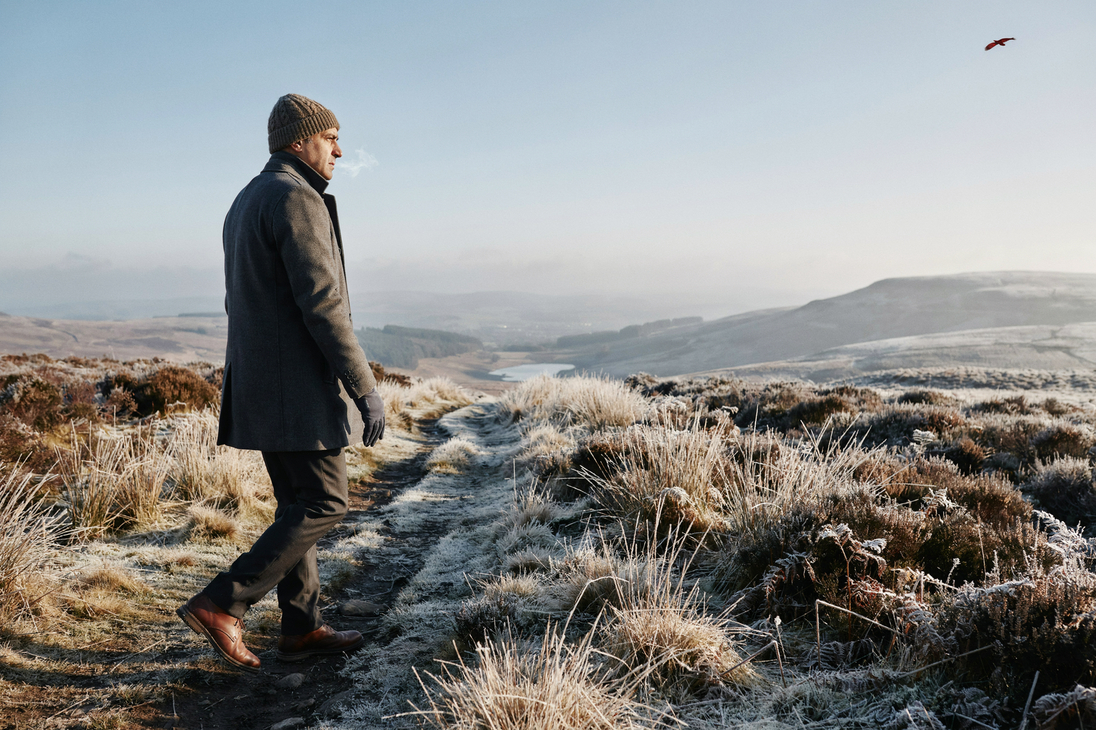 Adult walking in the Pentland Hills on the edge of Edinburgh on a frosty morning, with a COVID-19 vaccine timed around their treatment