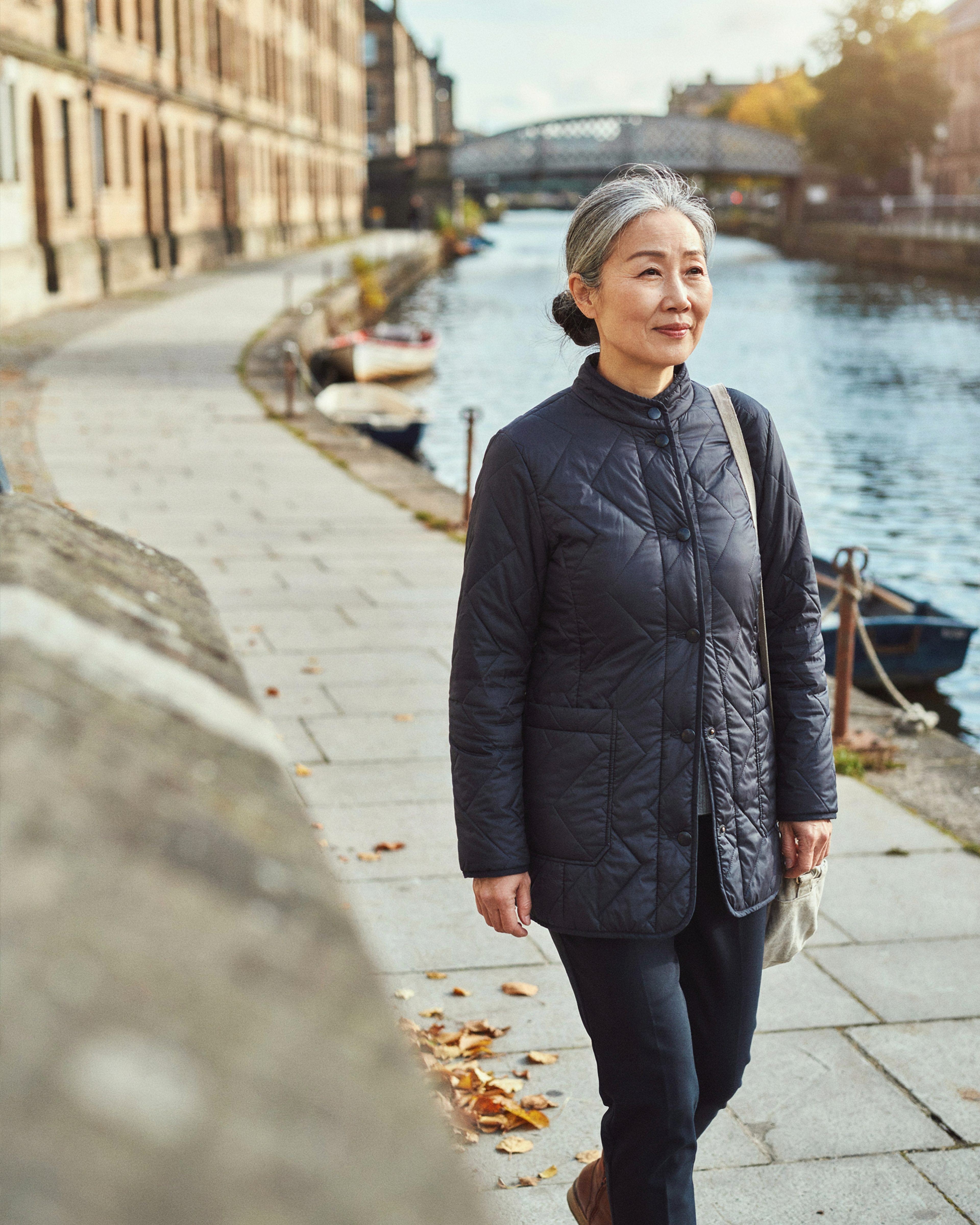 Adult walking along The Shore in Leith, Edinburgh, feeling well in the days after a COVID-19 vaccine
