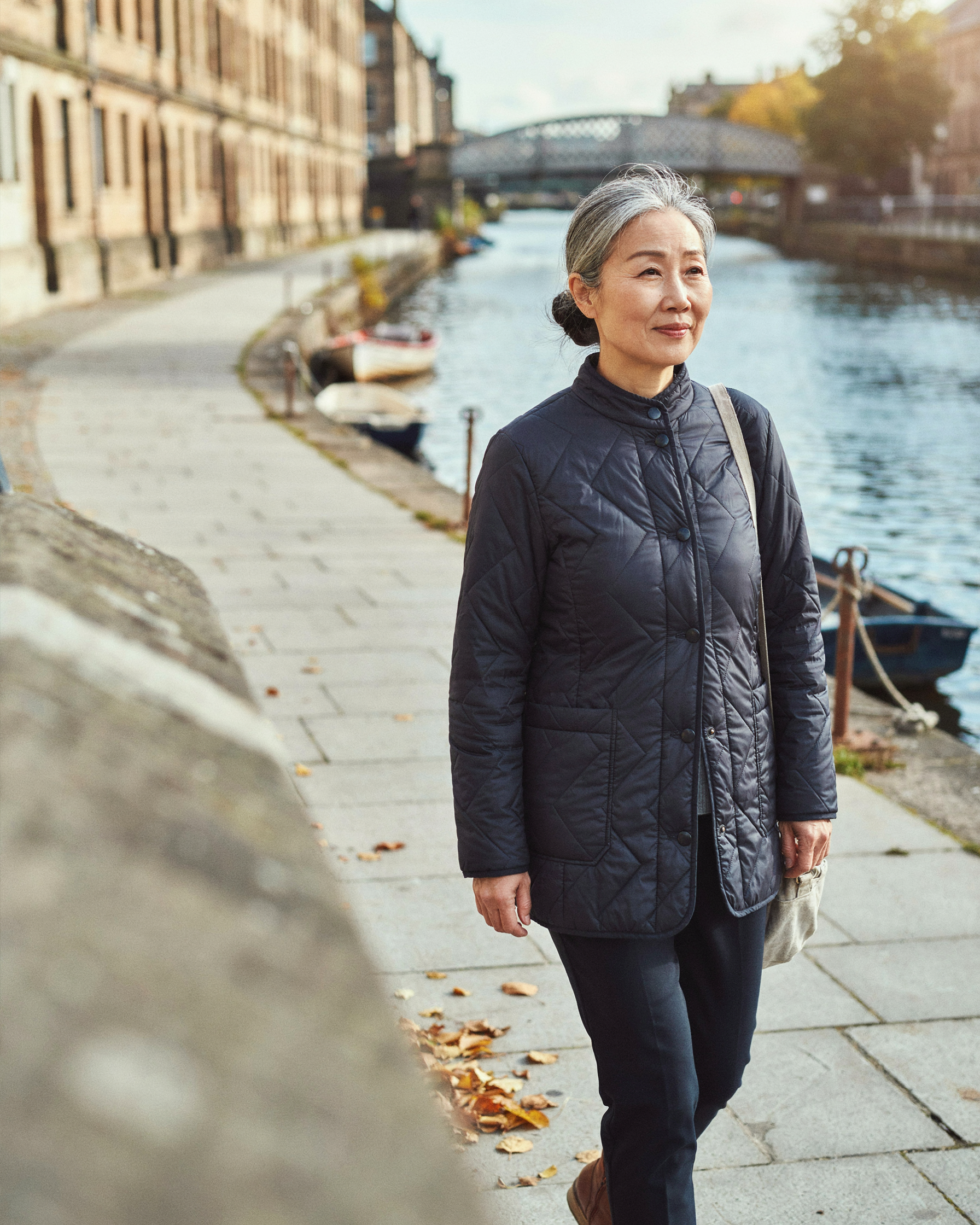 Adult walking along The Shore in Leith, Edinburgh, feeling well in the days after a COVID-19 vaccine