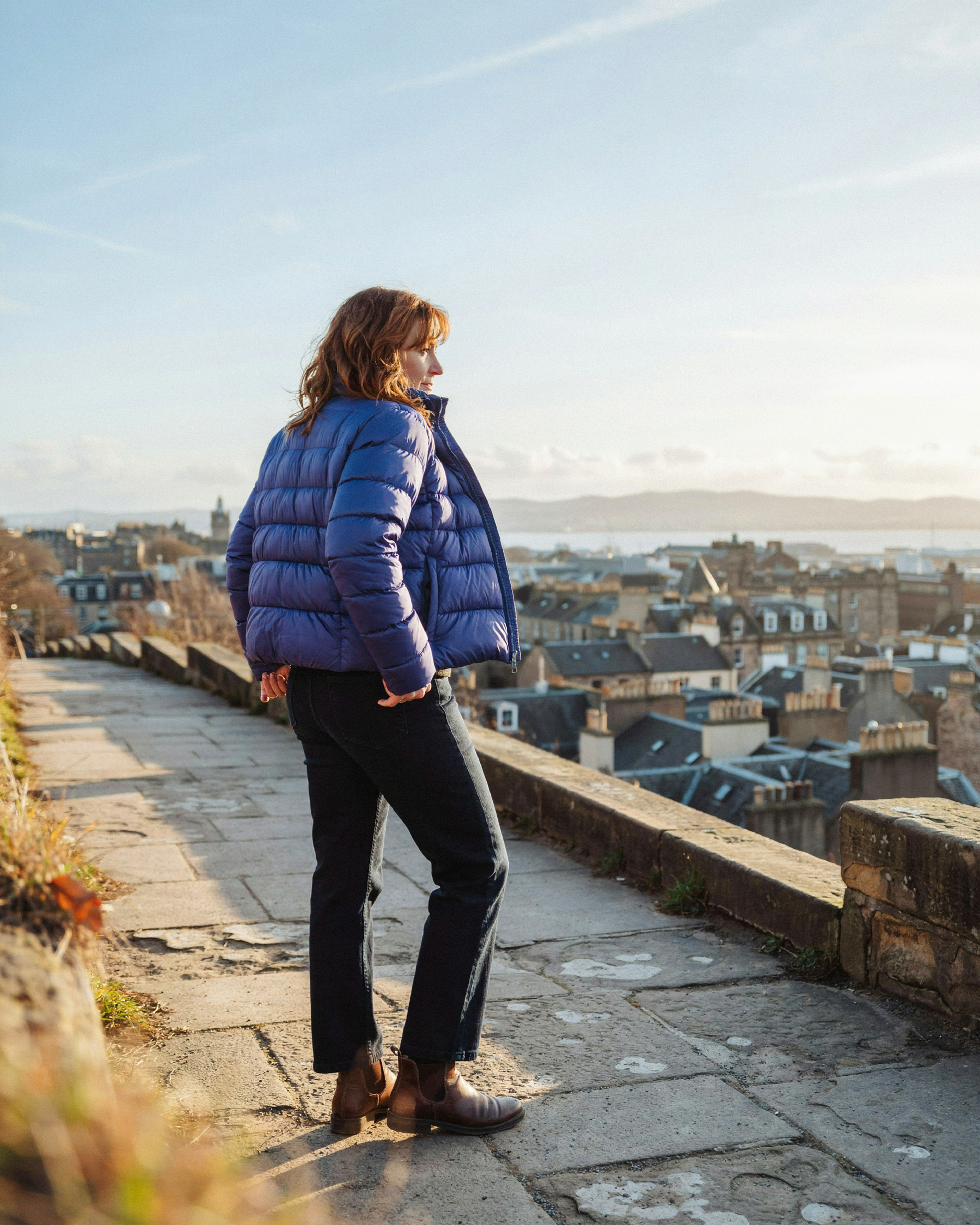 Adult on Calton Hill in Edinburgh on a winter afternoon, reassured after sorting out their flu vaccination
