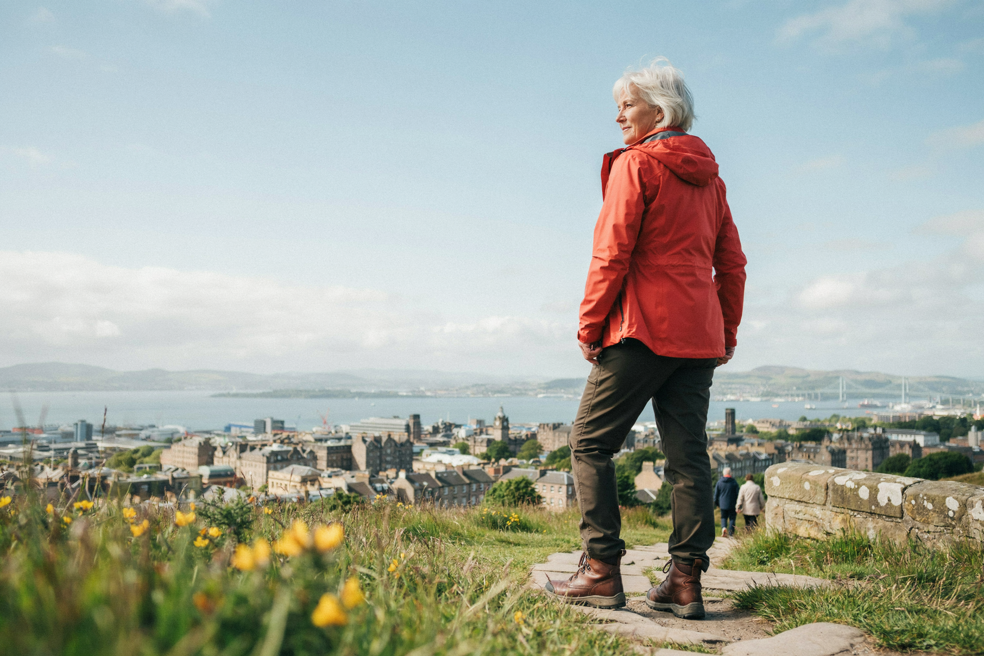 Adult pausing on Calton Hill in Edinburgh, looking out over the city, building strength and routine during weight management