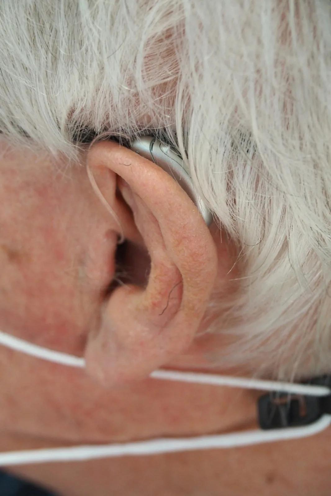 a close up of a person wearing a pair of ear phones