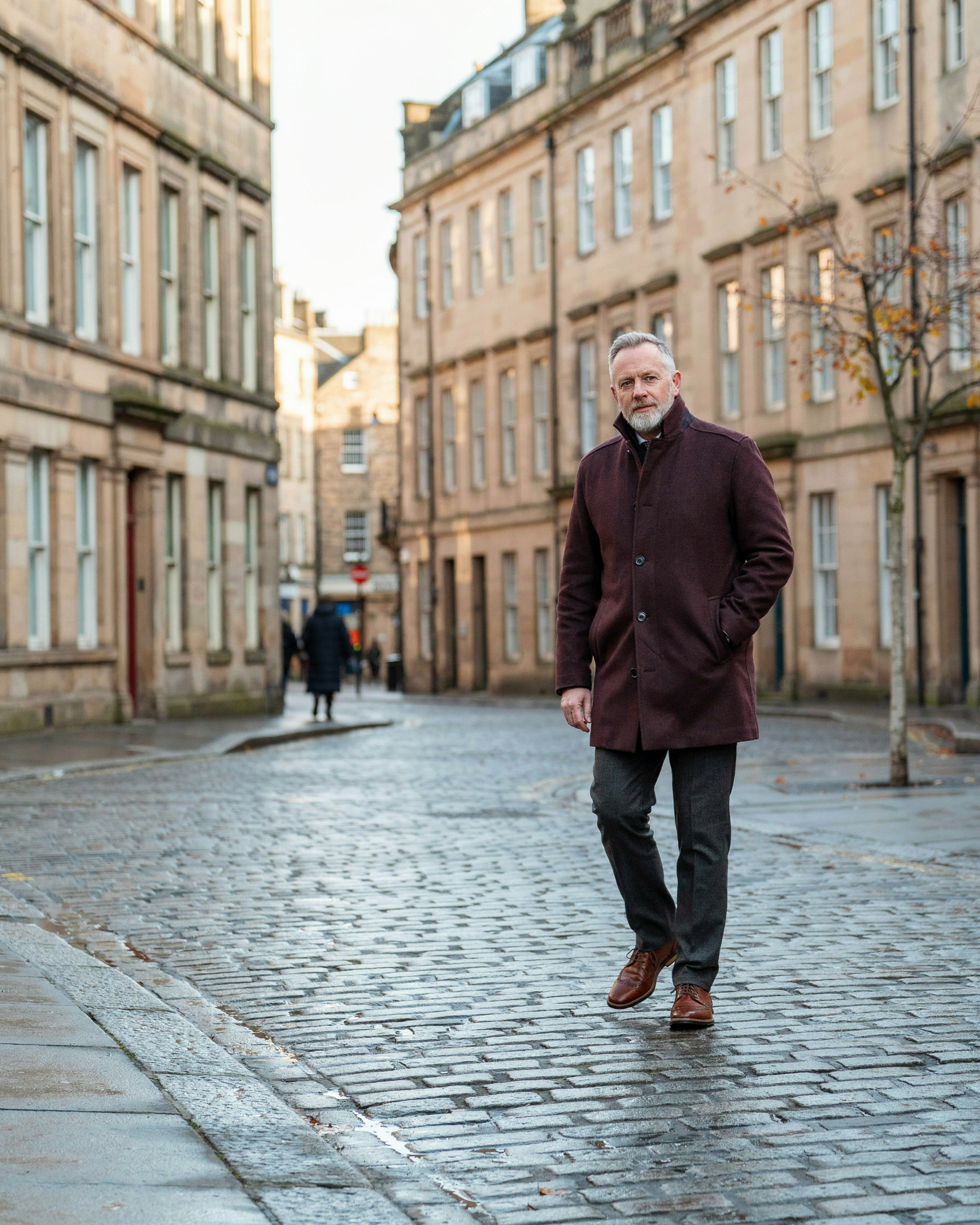Adult walking along the Royal Mile in Edinburgh on an autumn morning, a calm start to a weight management plan