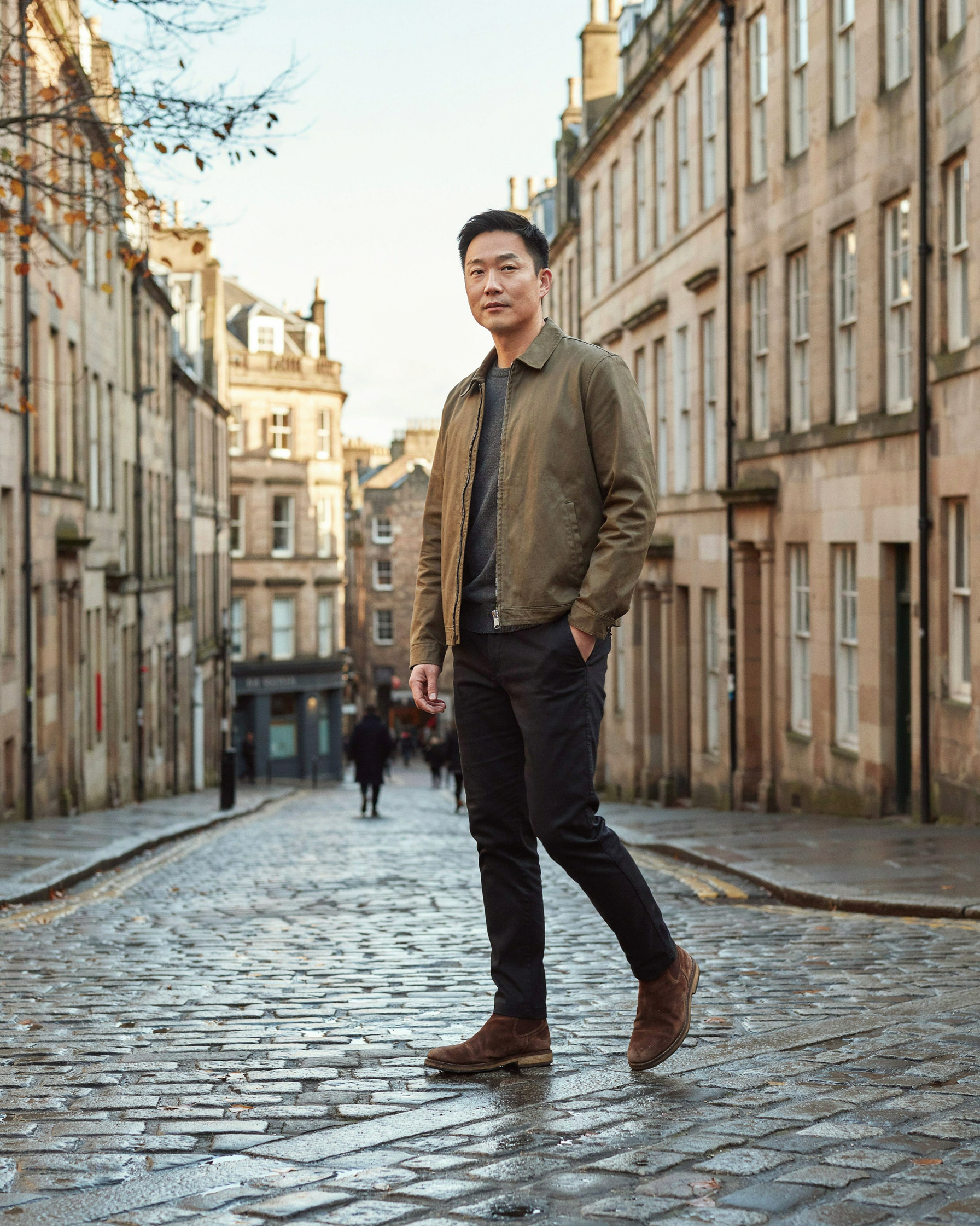 Adult walking along the Royal Mile in Edinburgh on a late autumn morning, the best time of year for a flu jab