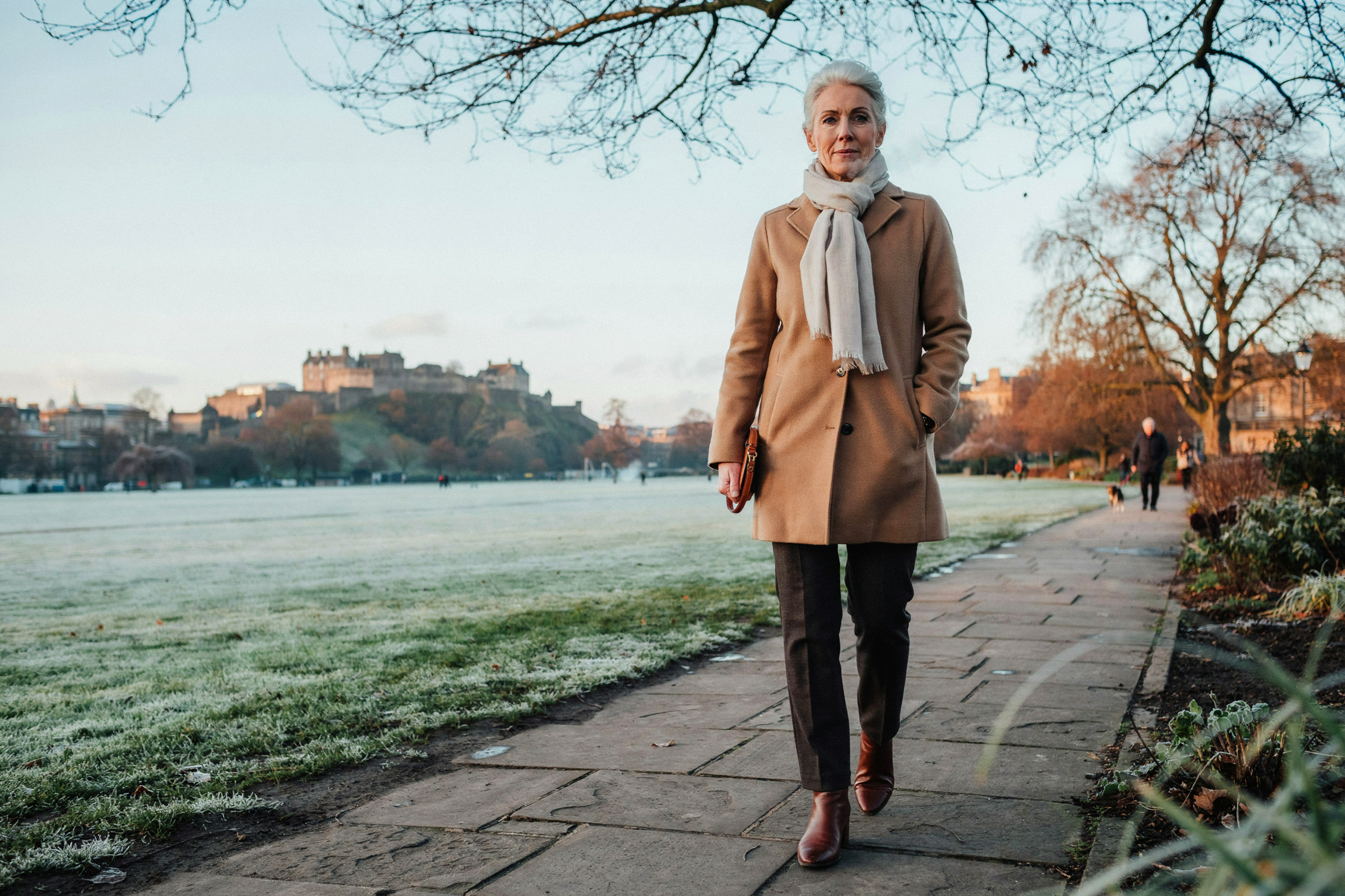 Adult walking through Princes Street Gardens in Edinburgh on a frosty winter morning during the flu season peak