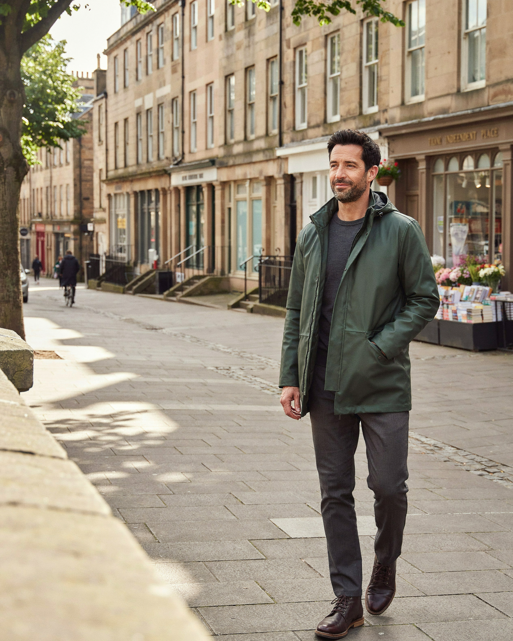 Adult walking along Bruntsfield Place in Edinburgh on a bright afternoon, content after a pharmacist consultation