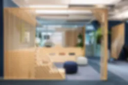 Communication area with a wooden theatre-like furniture and poufs