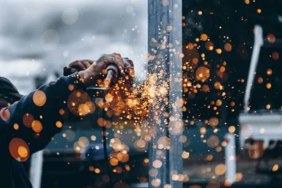 Contractor holding tool with sparks flying