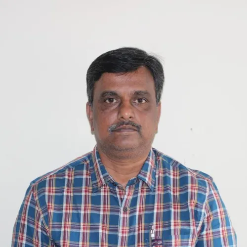 a man in a plaid shirt is posing for a picture .