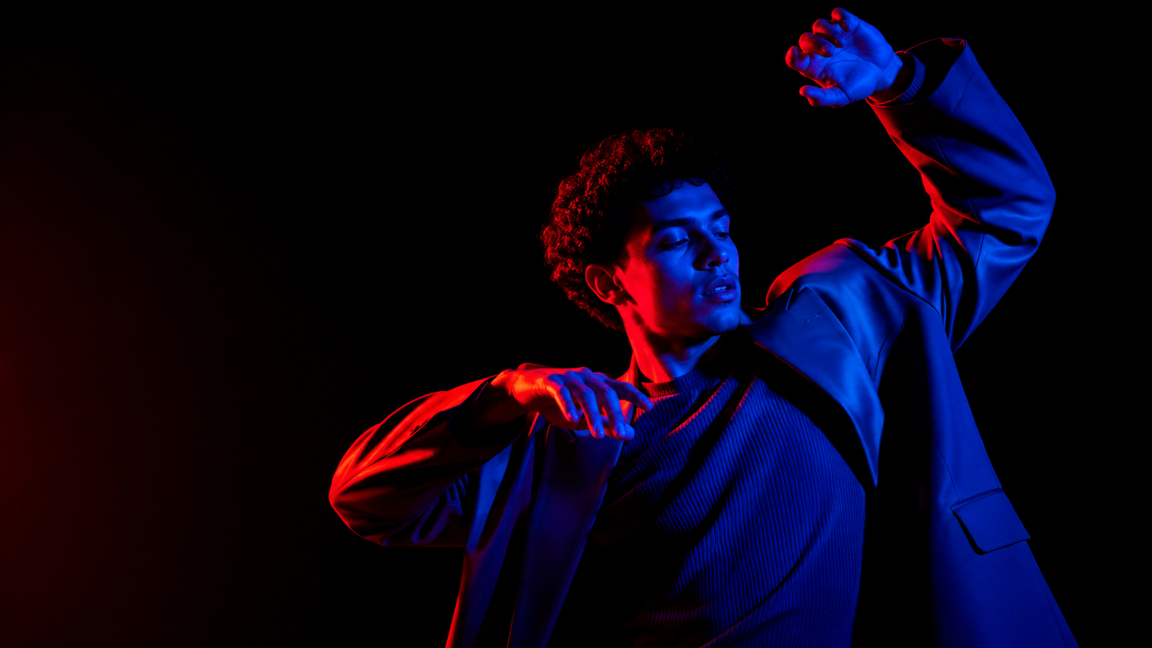 Stylish portrait of a dancing person in neon light