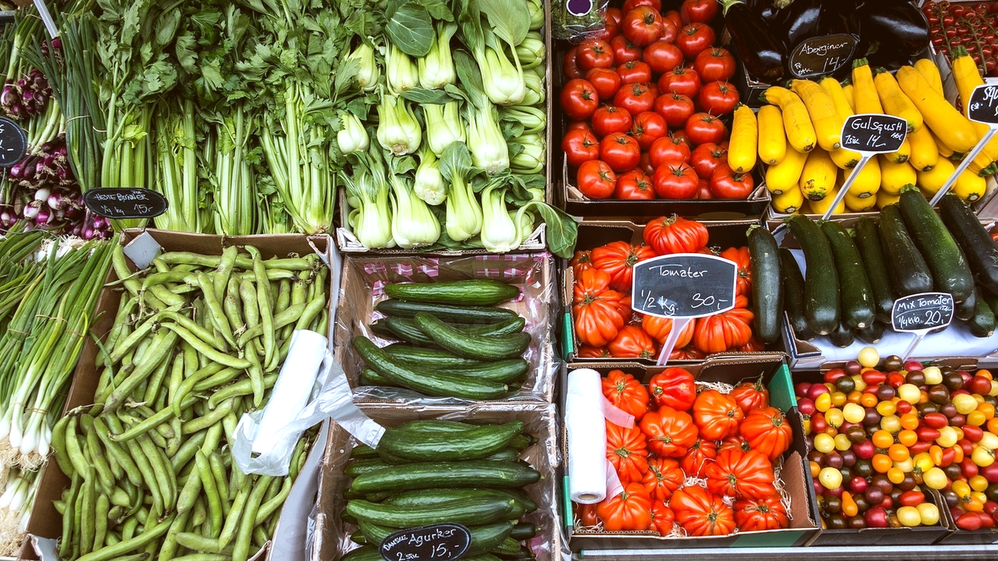 Fresh produce on a market stall with chalk price signs