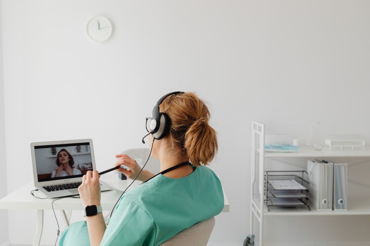 A doctor at her desk doing a telehealth appointment.
