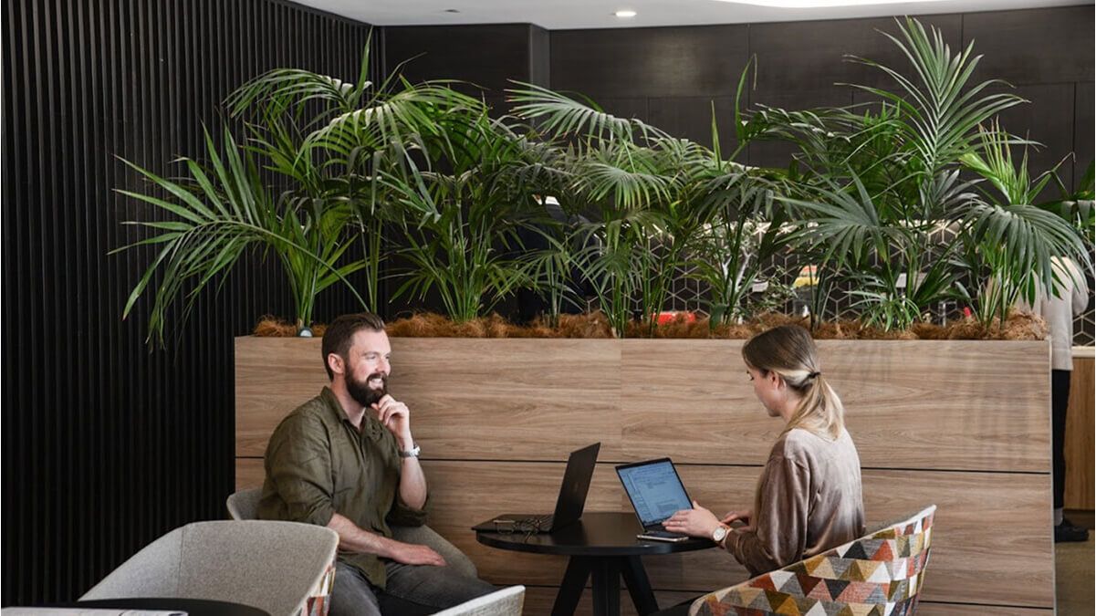 Airteam's head of operations and project manager sitting at a desk discussing software security