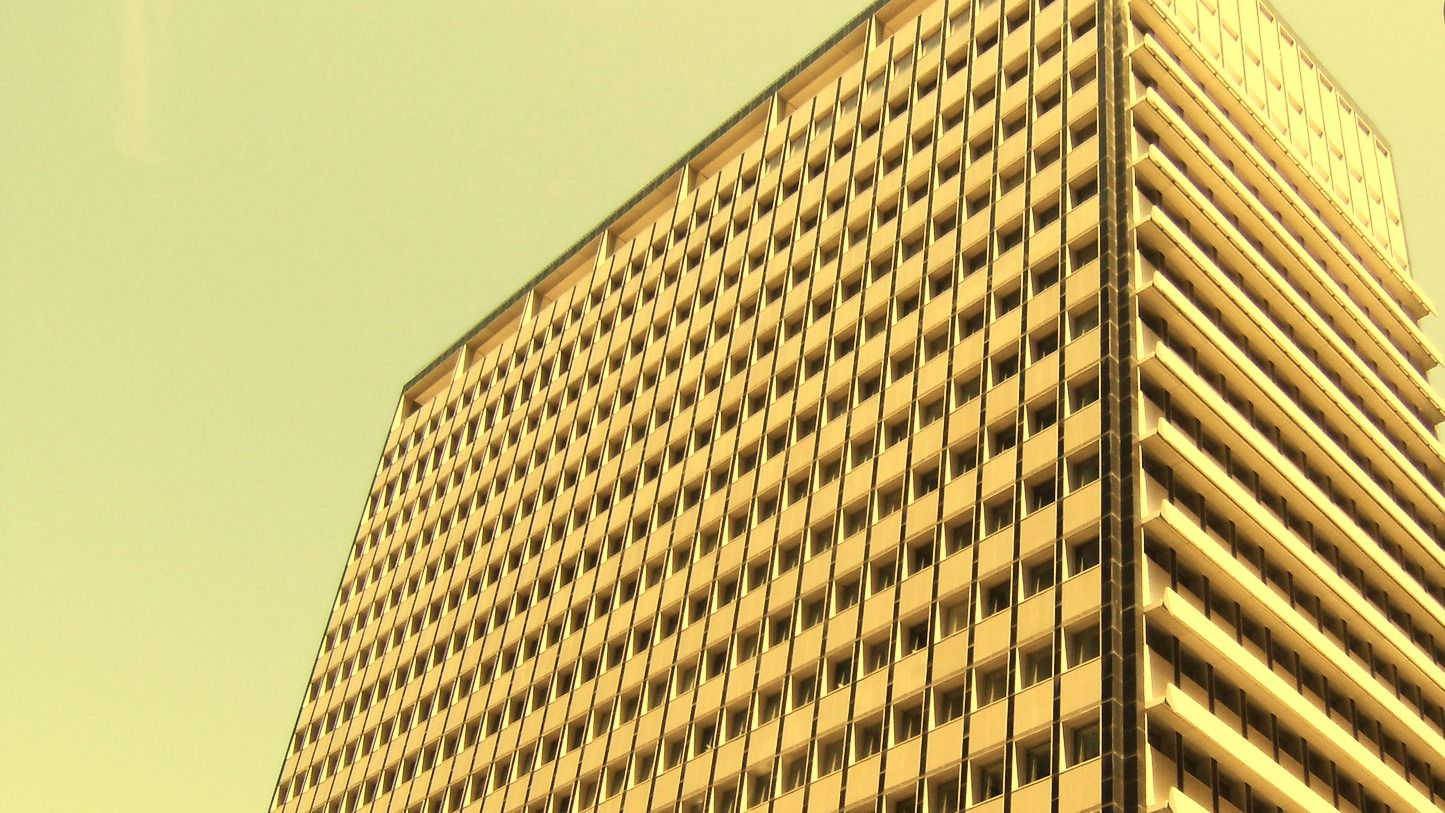 The Reserve Bank of Australia building in Martin Place, Sydney, photographed from street level under a warm sky