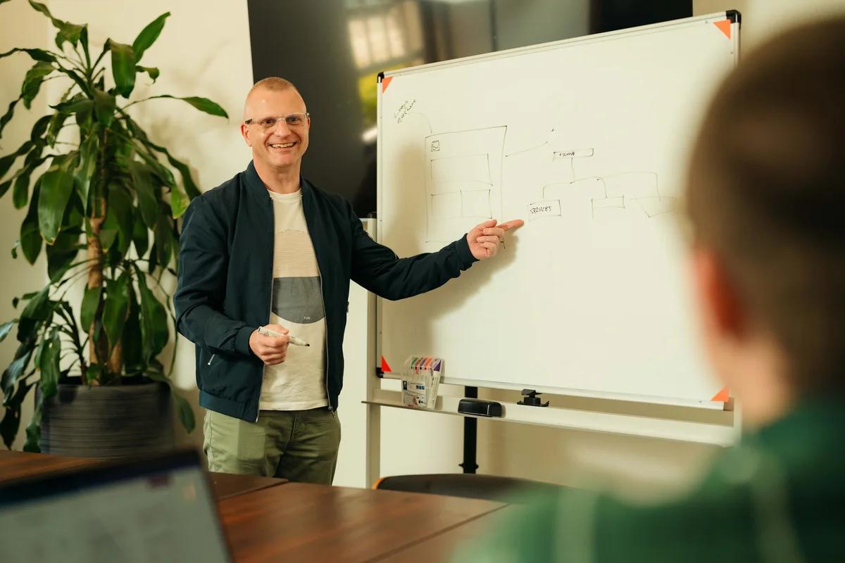 Airteam director presenting at a whiteboard