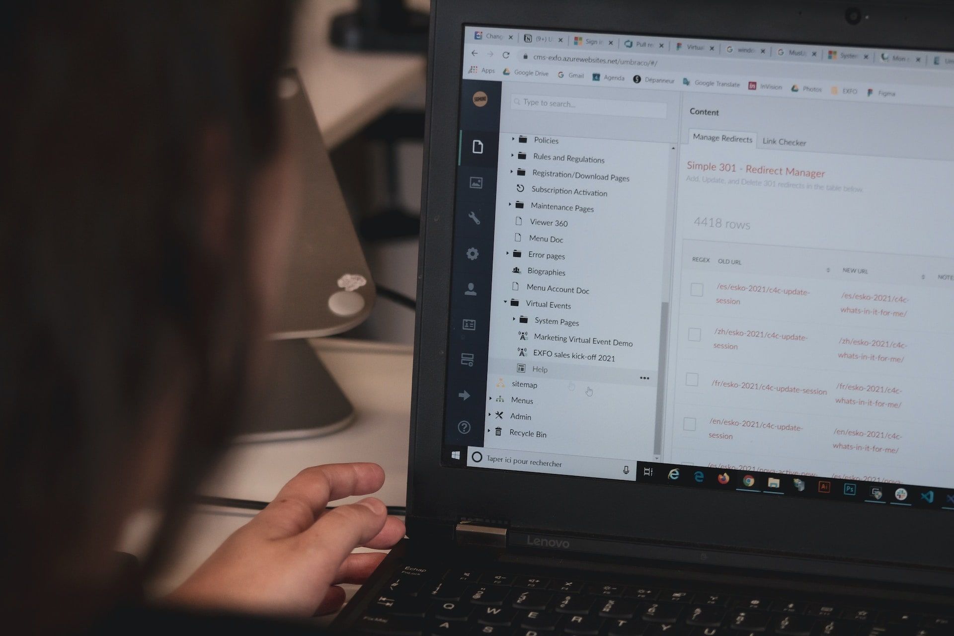 A laptop screen showing the backend of a content management system being worked on by a developer.