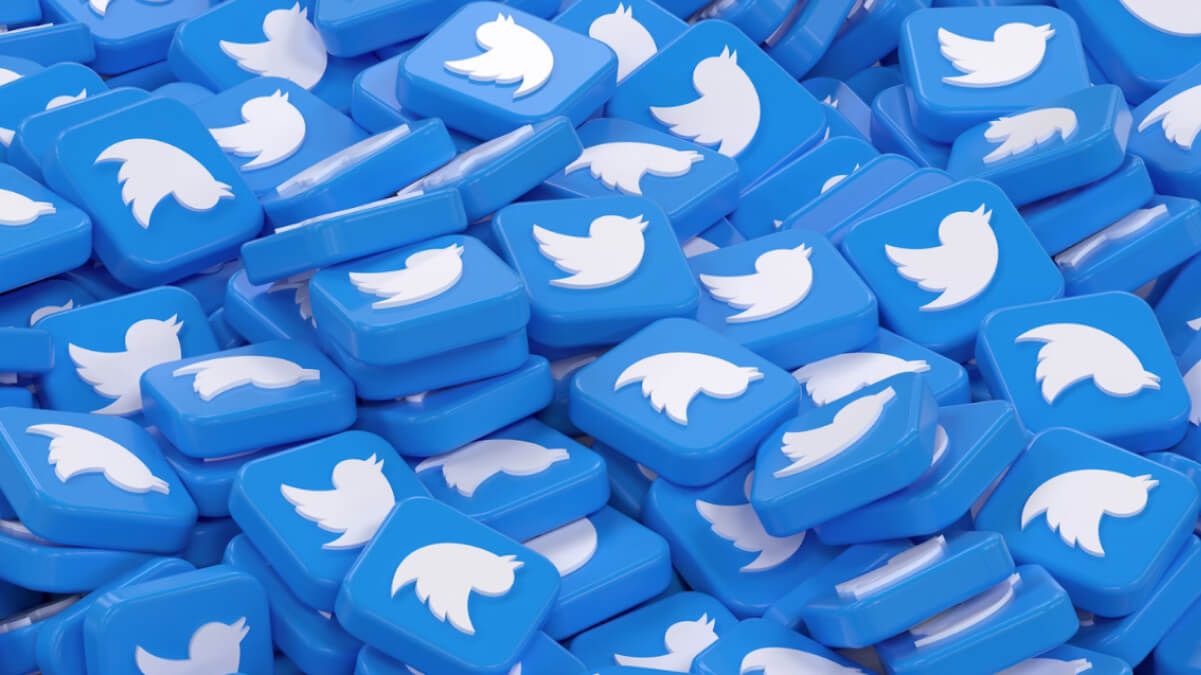 A large pile of glossy blue 3D tiles featuring the classic white Twitter bird logo.