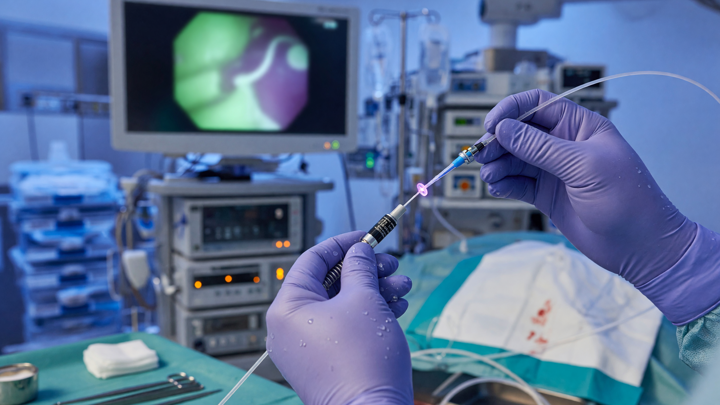 Surgeon performing laser piles treatment using a laser fibre in a modern operating room