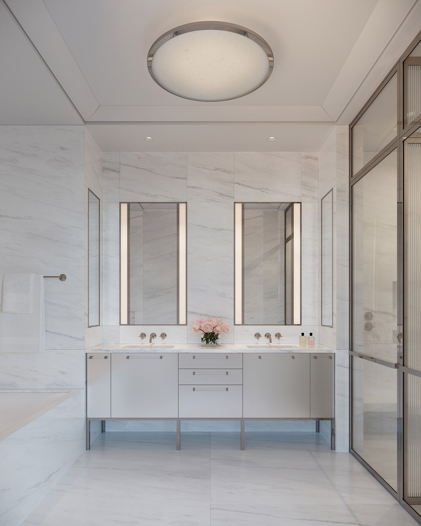 Primary bathroom featuring slabs of Olympic Danby marble