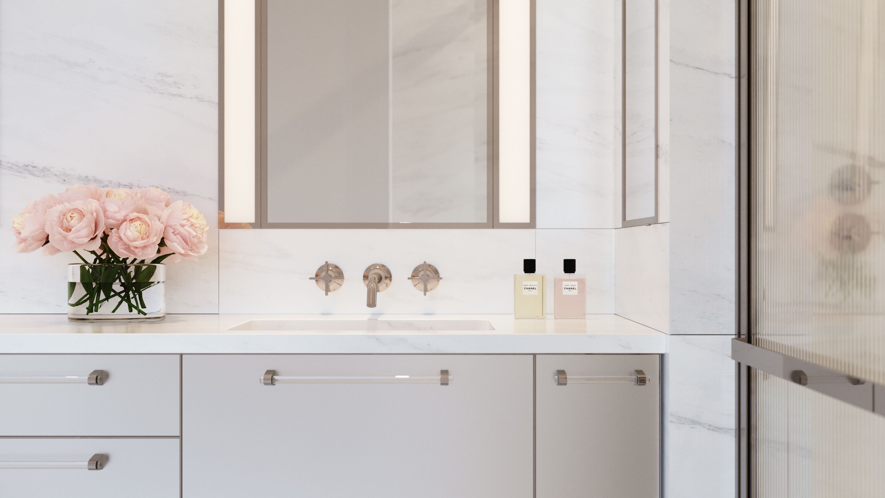 Luxurious details include Dornbracht Vaia fittings in polished nickel, custom recessed medicine cabinets, and vanities clad in acid etched glass