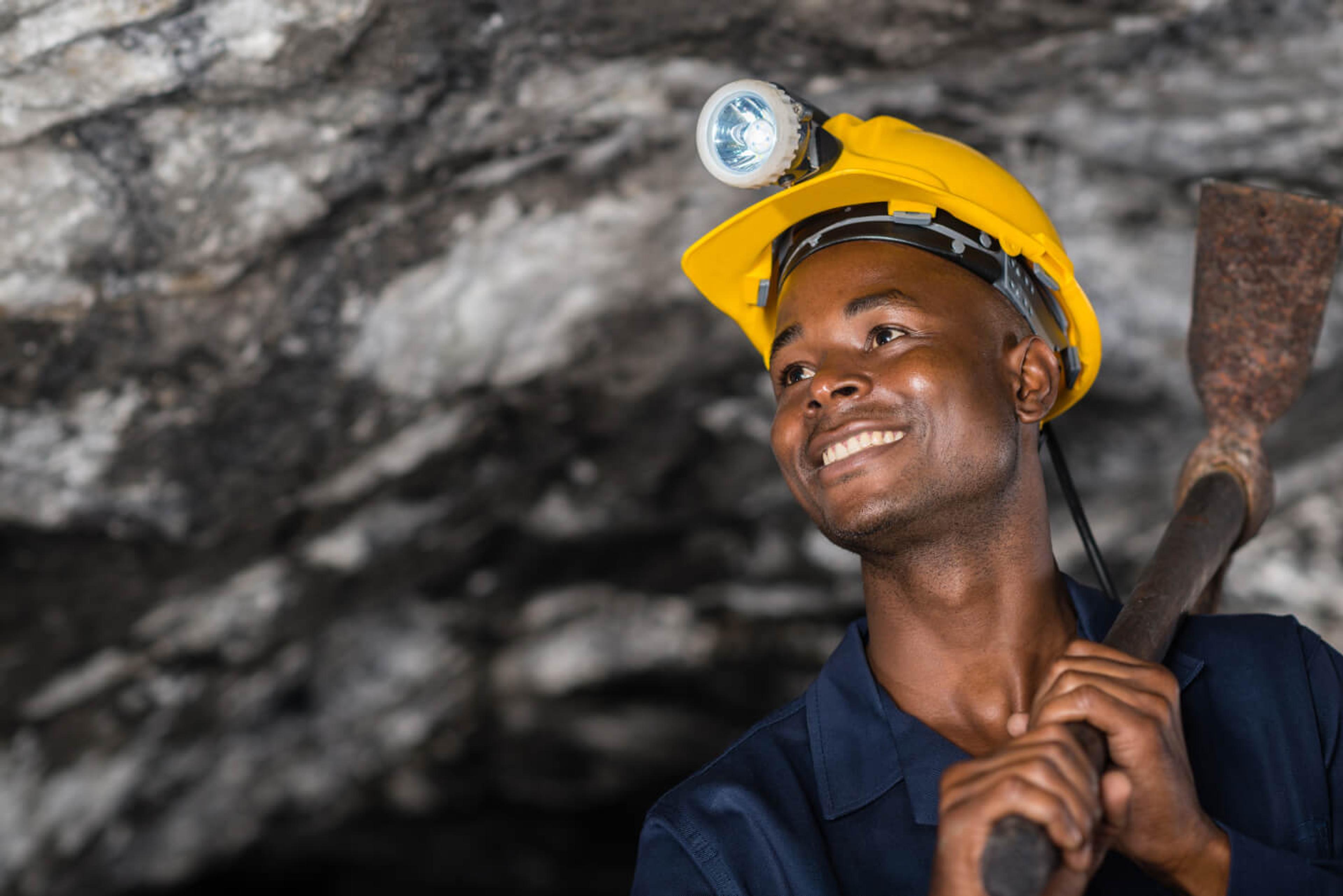 A smiling worker in a mine