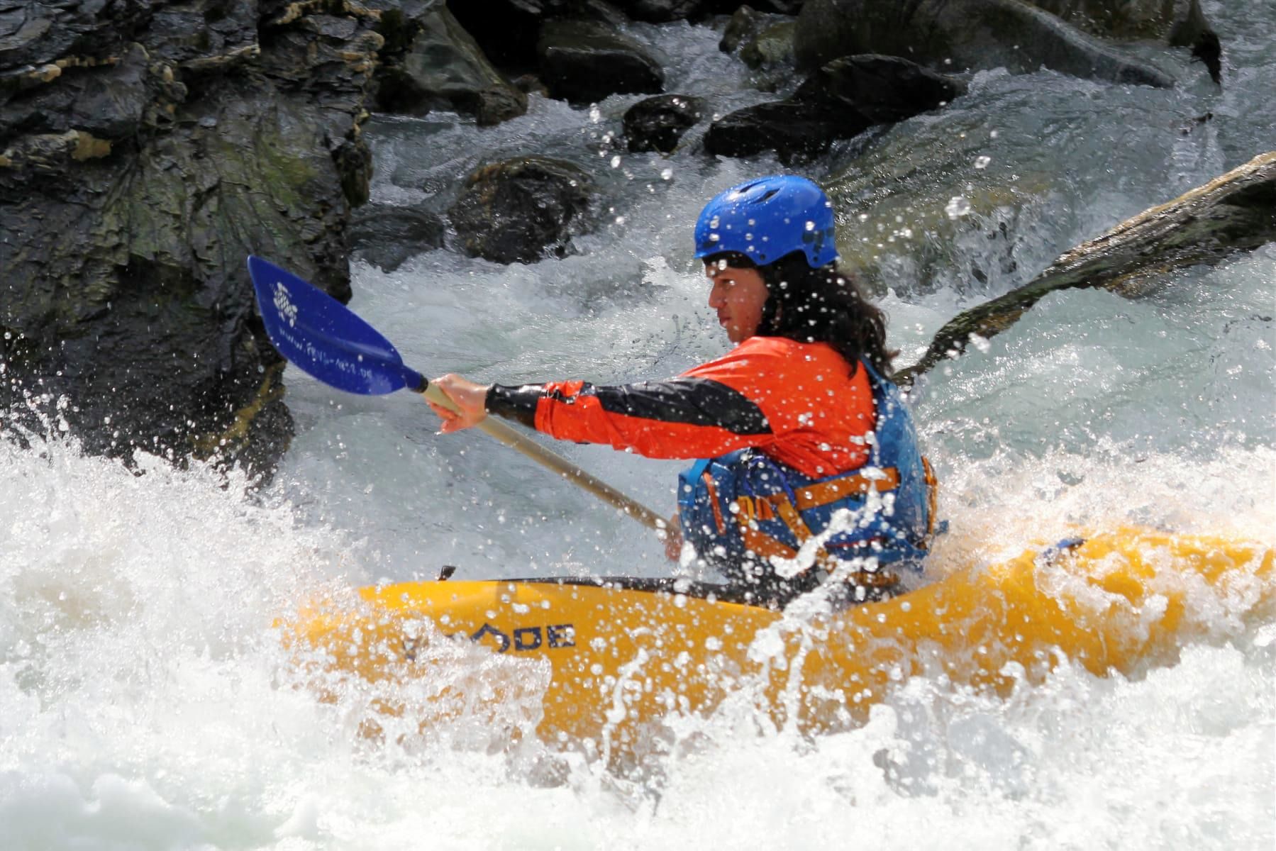 Kayak in whitewater – paddler in the middle of the rapids