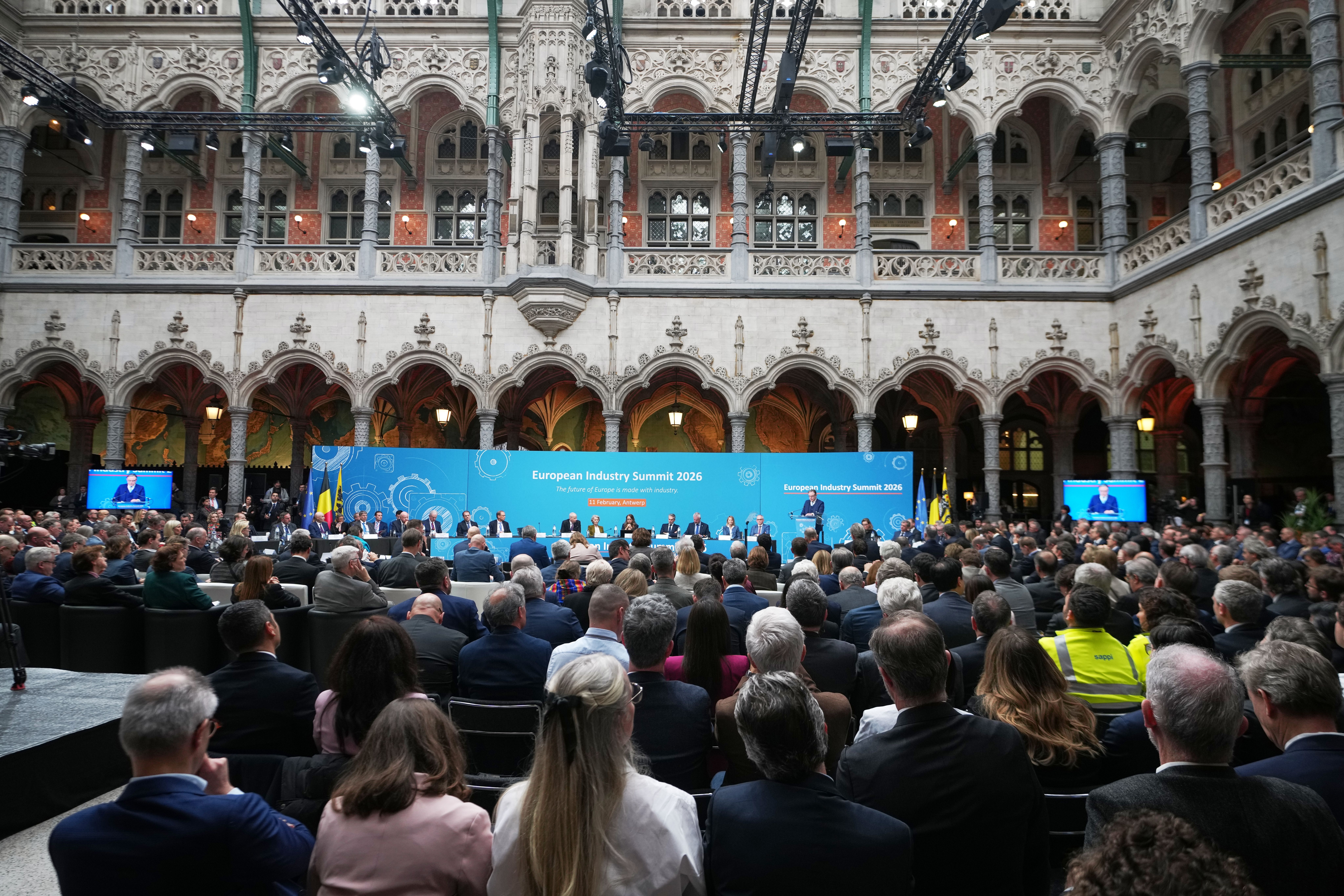 A speaker addresses a large audience at the European Industry Summit 2024 in an ornate hall.