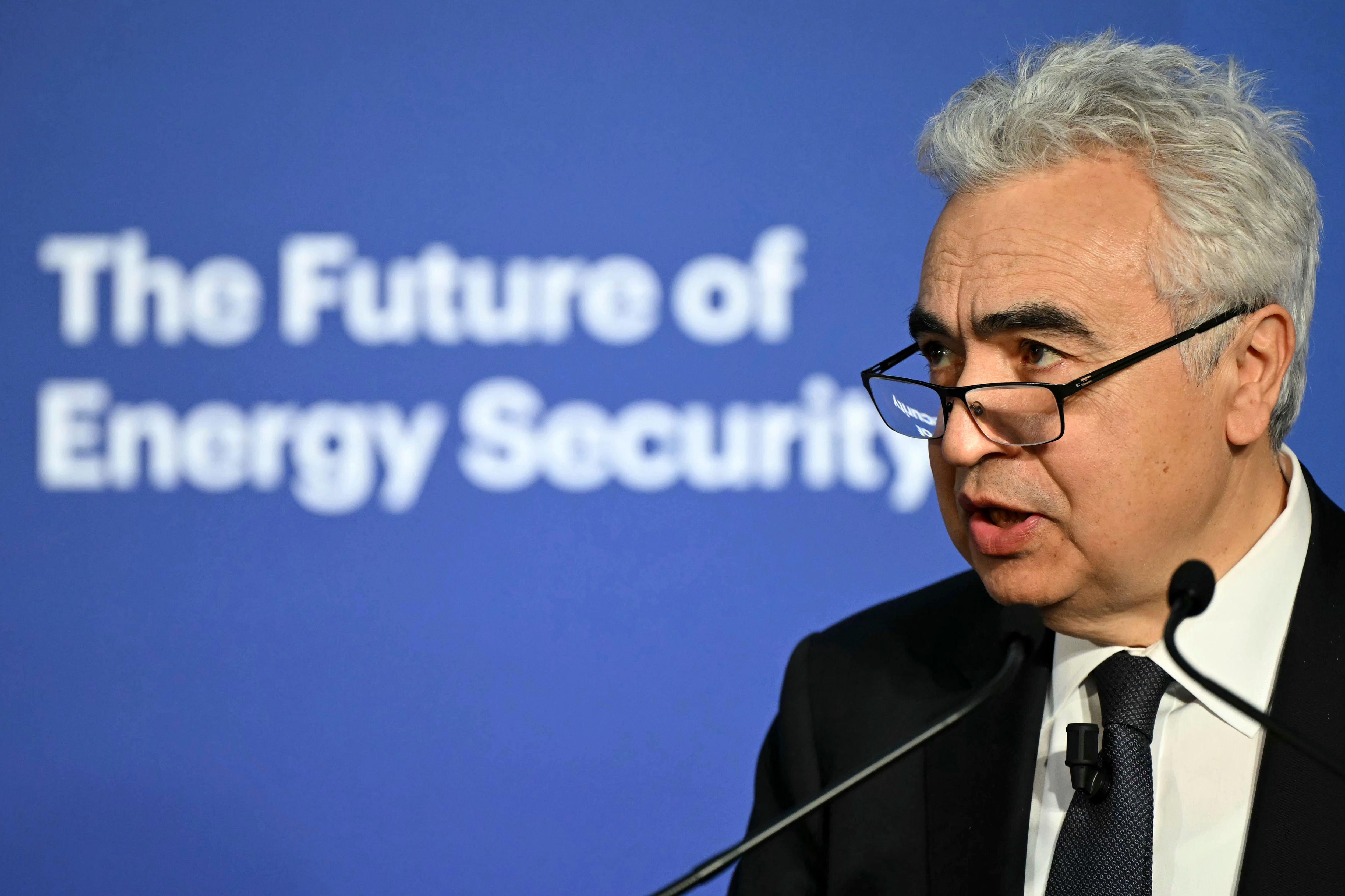 Fatih Birol speaking at a podium with "The Future of Energy Security" on a blue background.