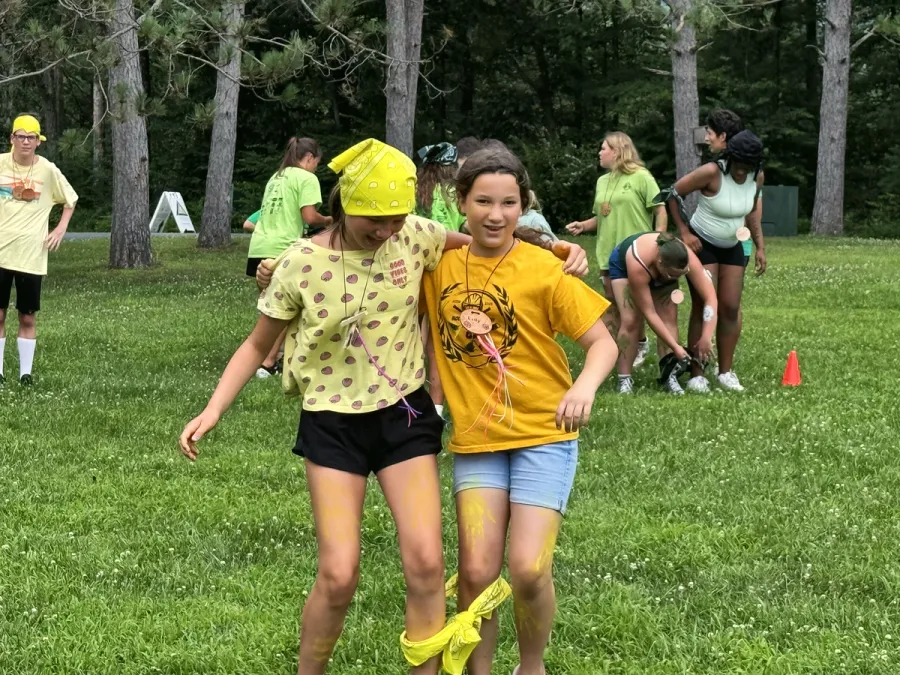 Two girls in a three-legged race on the field