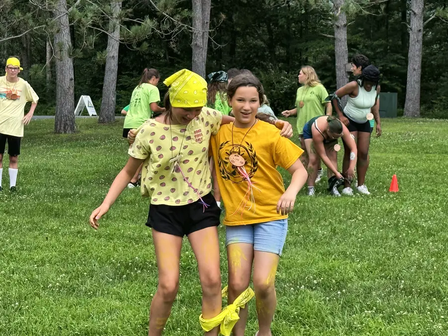 Two girls in a three-legged race on the field