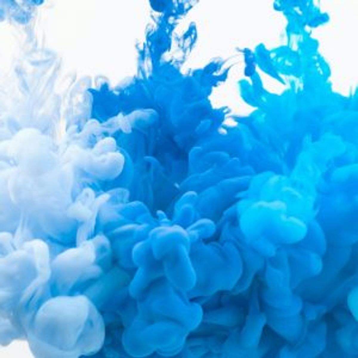 Blue and white ink clouds swirling in water