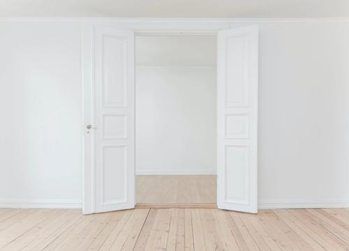 Empty white doorway with wood floors