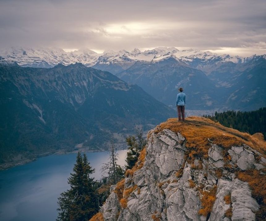 A man standing by some cliffs