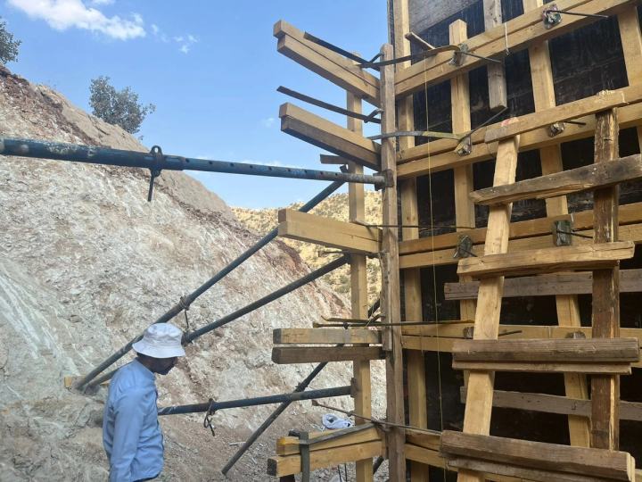 Workers installing pipe in a trench