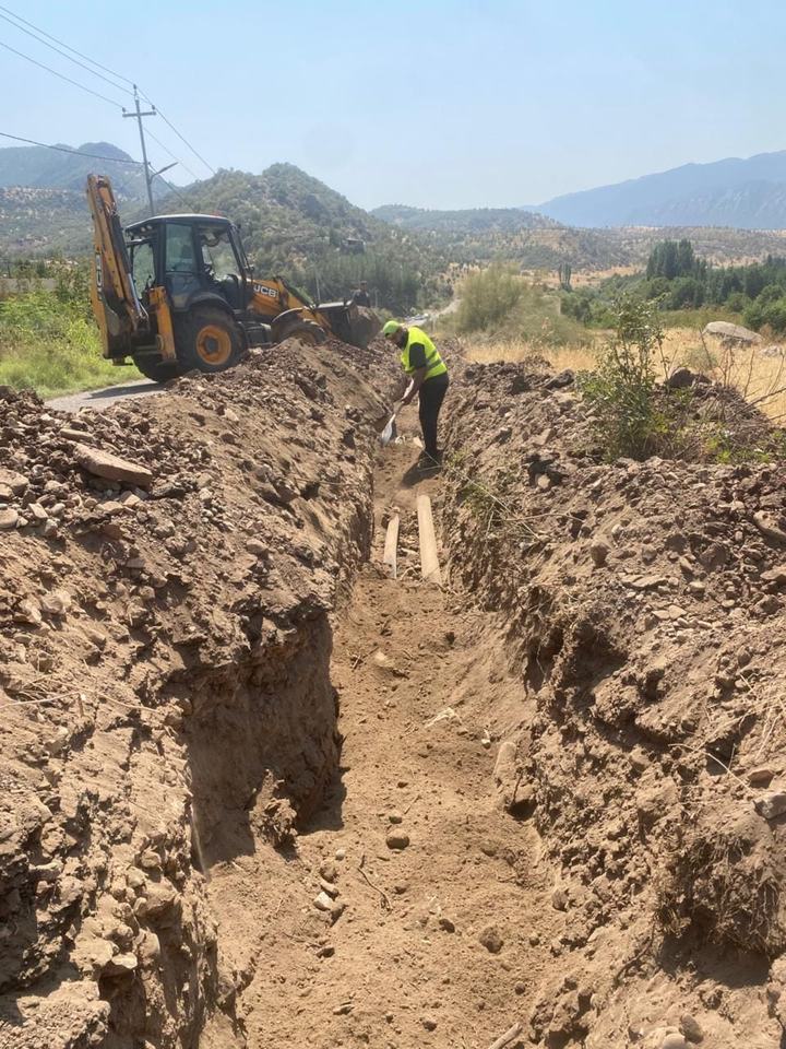 Excavator digging a trench